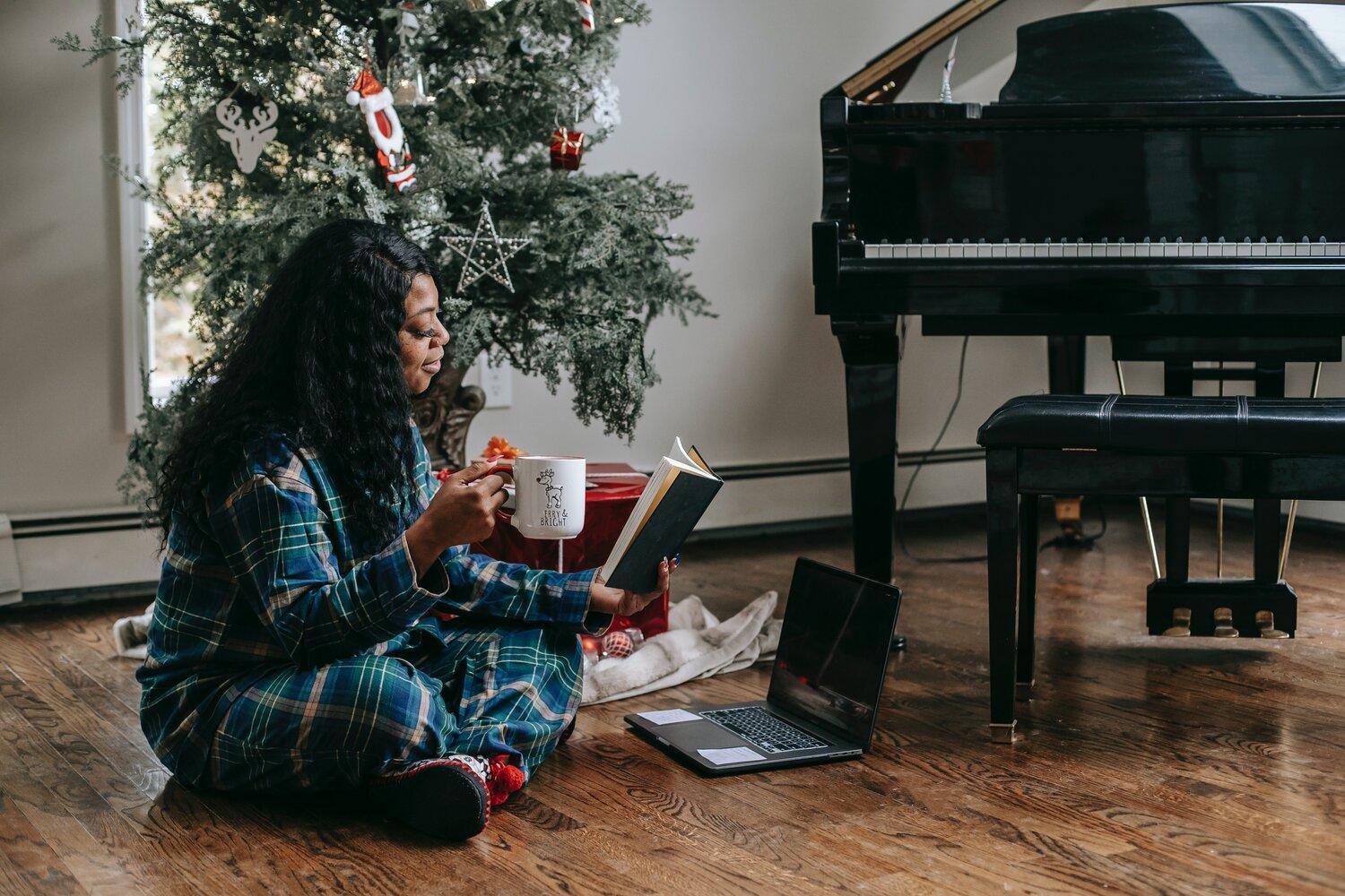 A woman sitting beside the piano