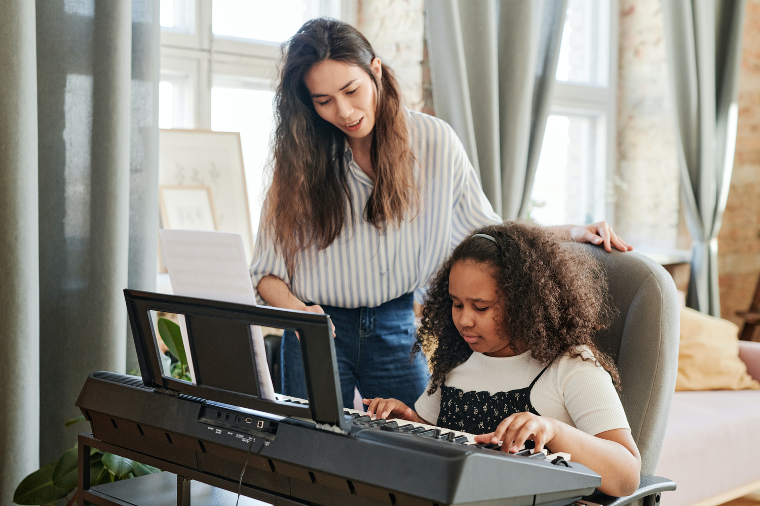 A student and teacher ojn the piano