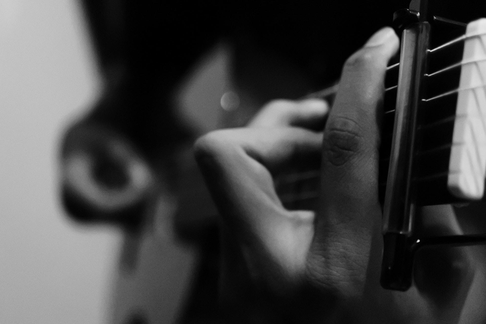 black and white playing guitar