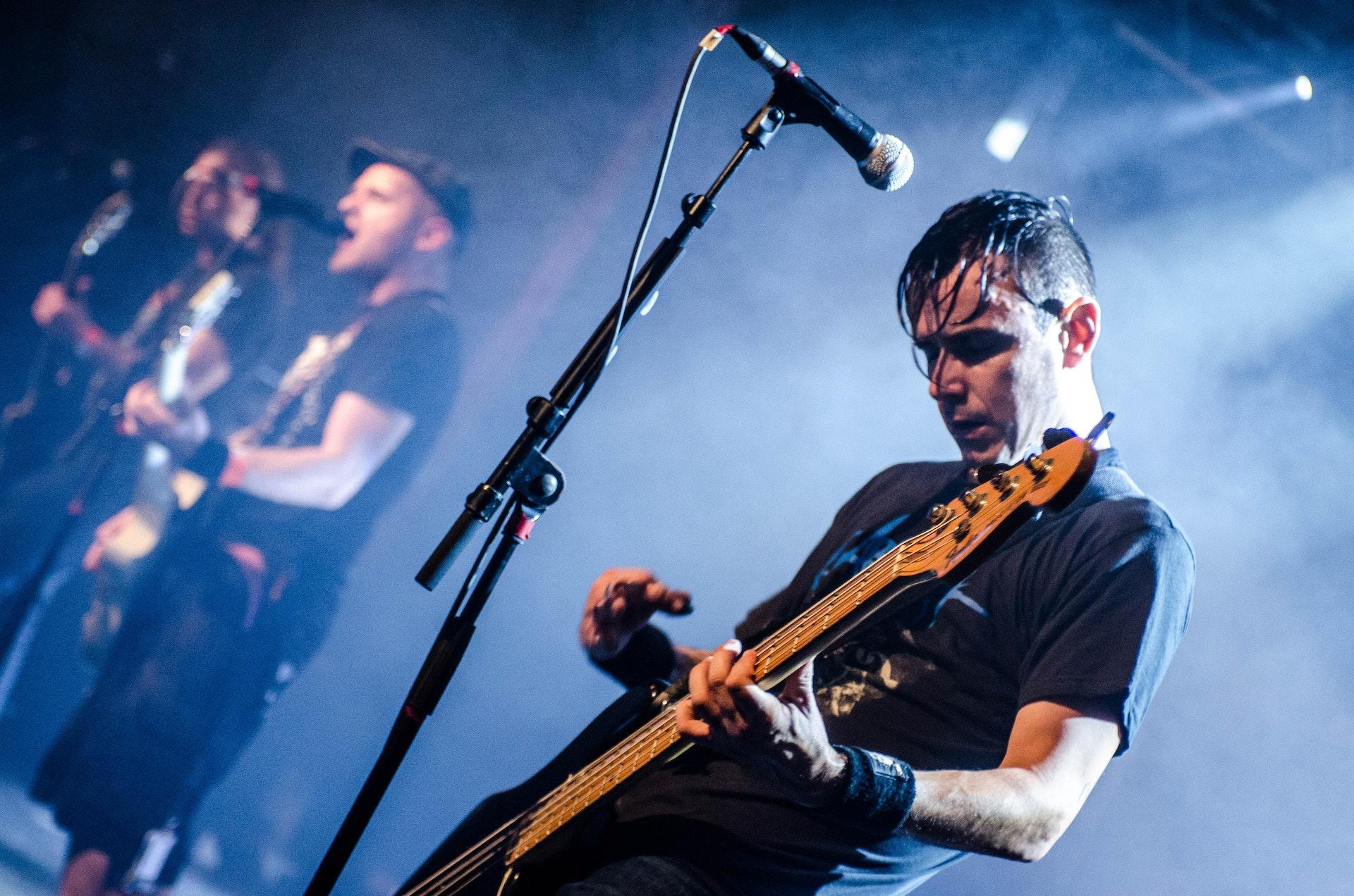 man play guitar at concert