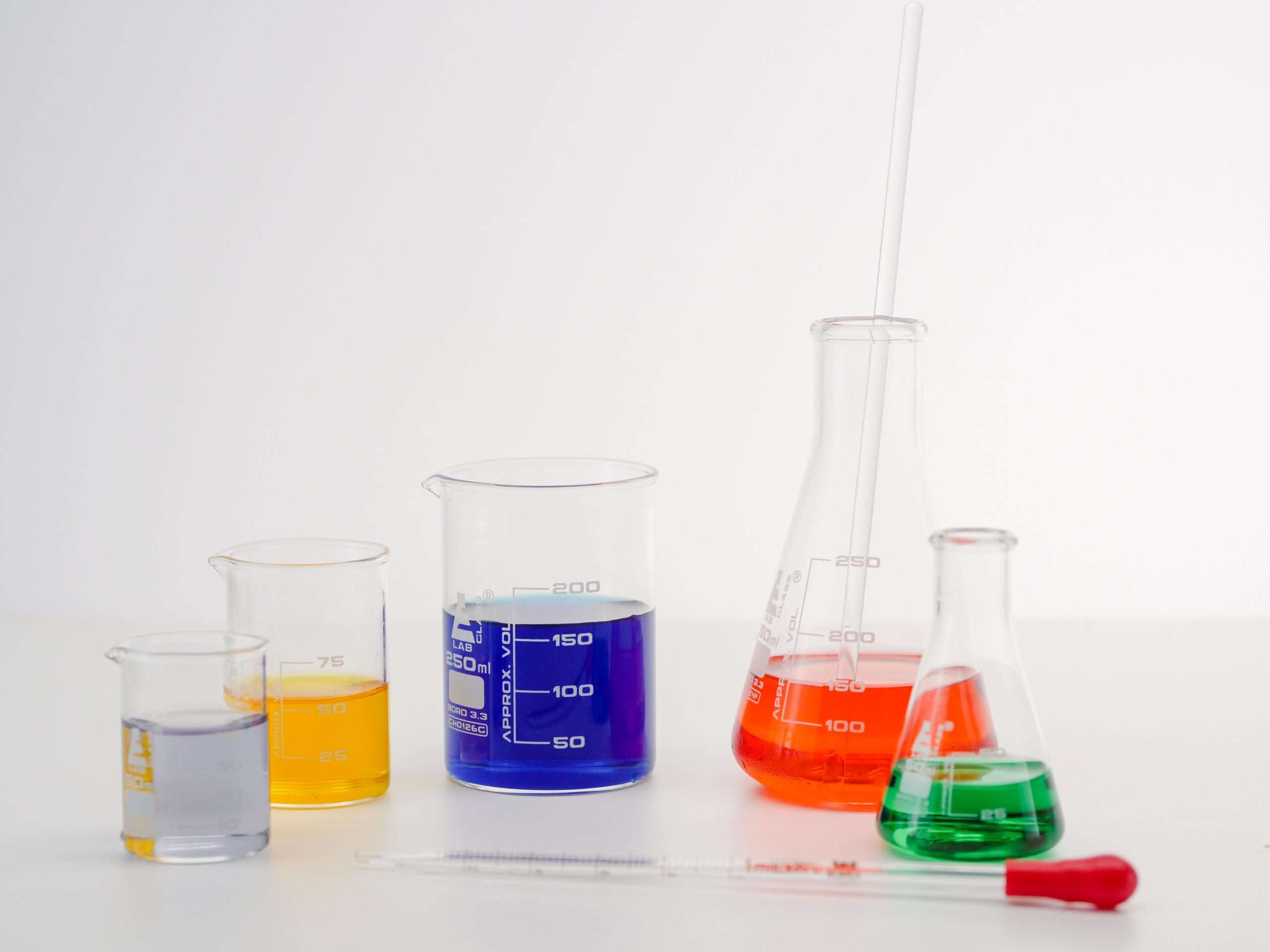 Multiple flasks containing colourful liquids.
