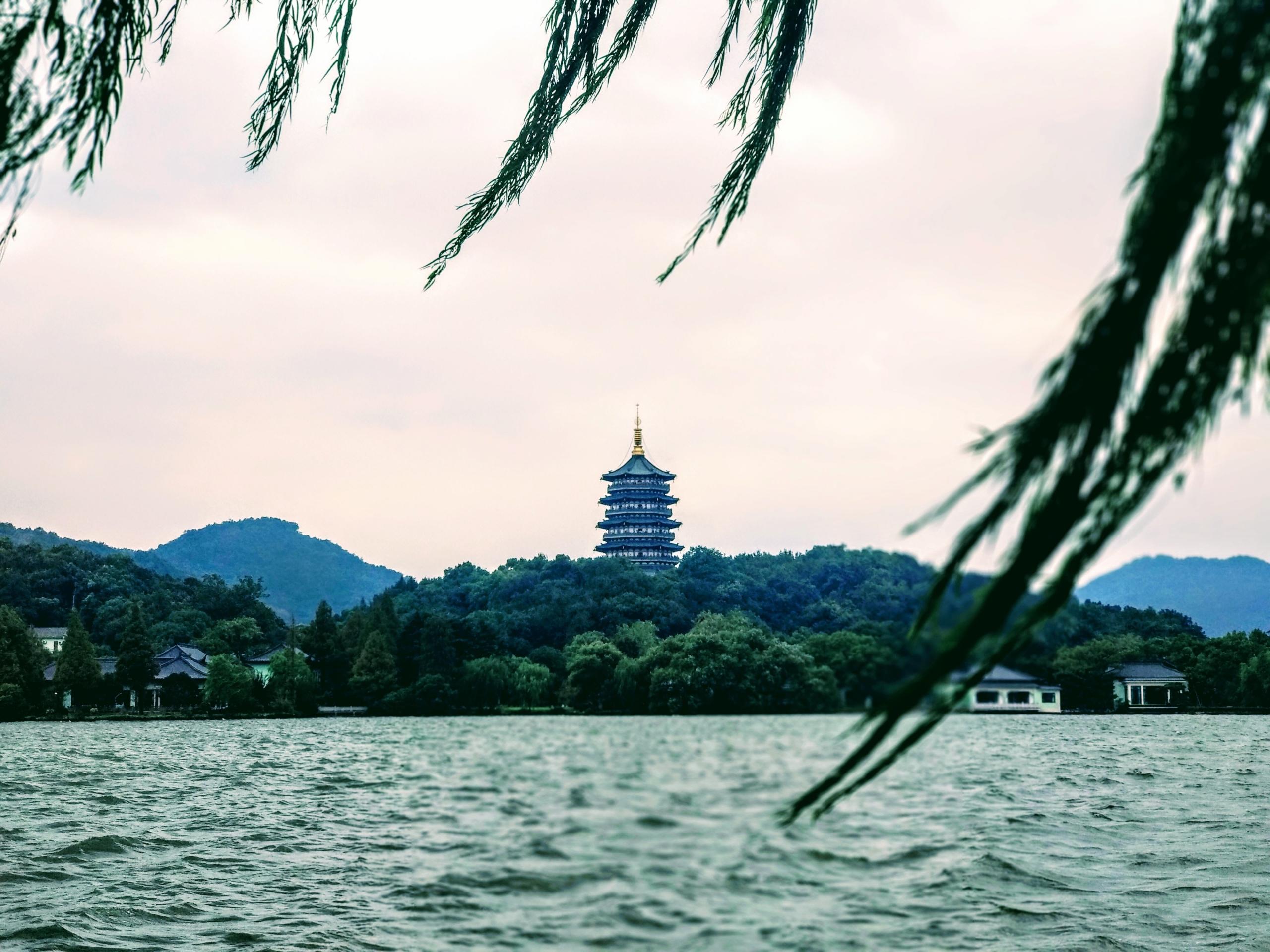 A traditional building in China on a lake.