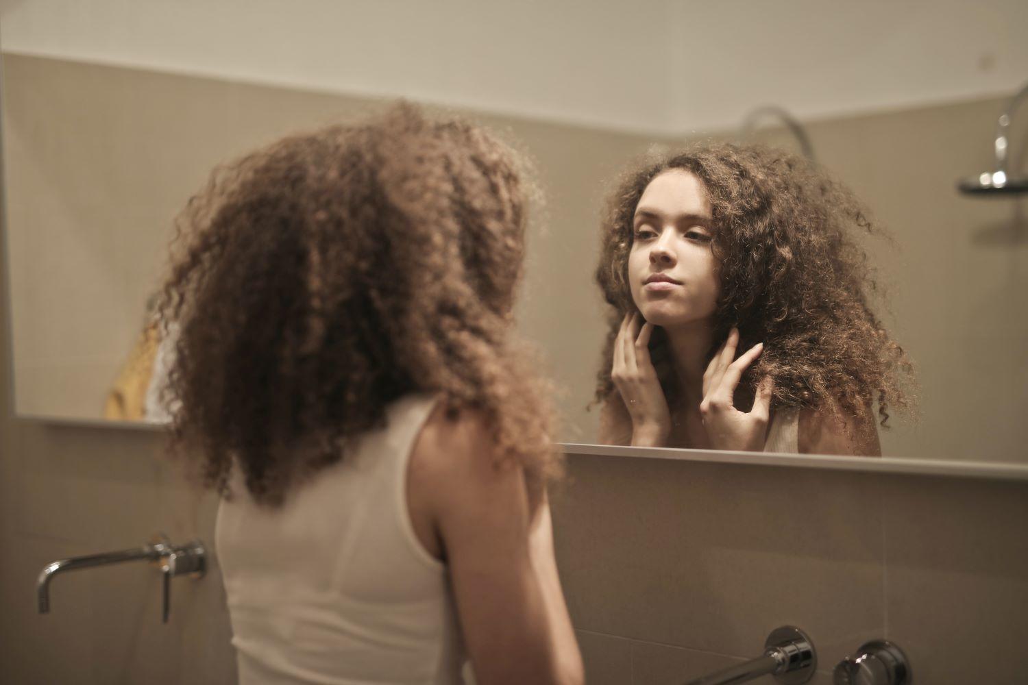 A woman looking at the mirror