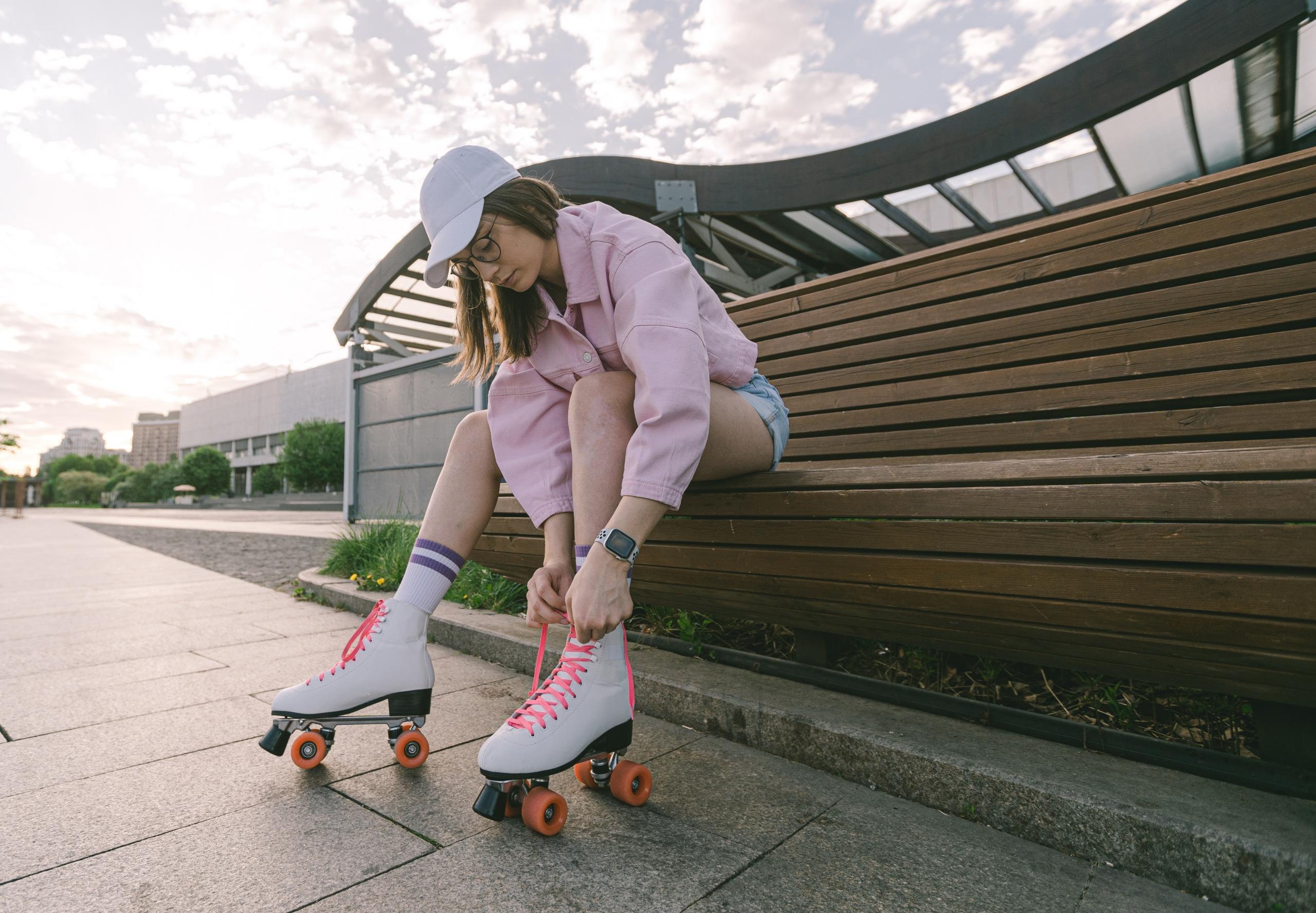 A woman puts on her roller skates.