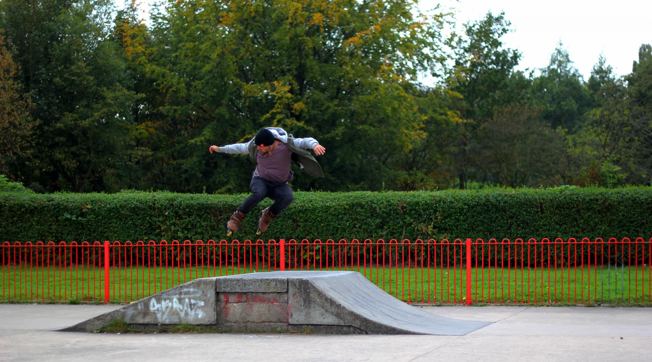 A skater performs tricks on a ramp.