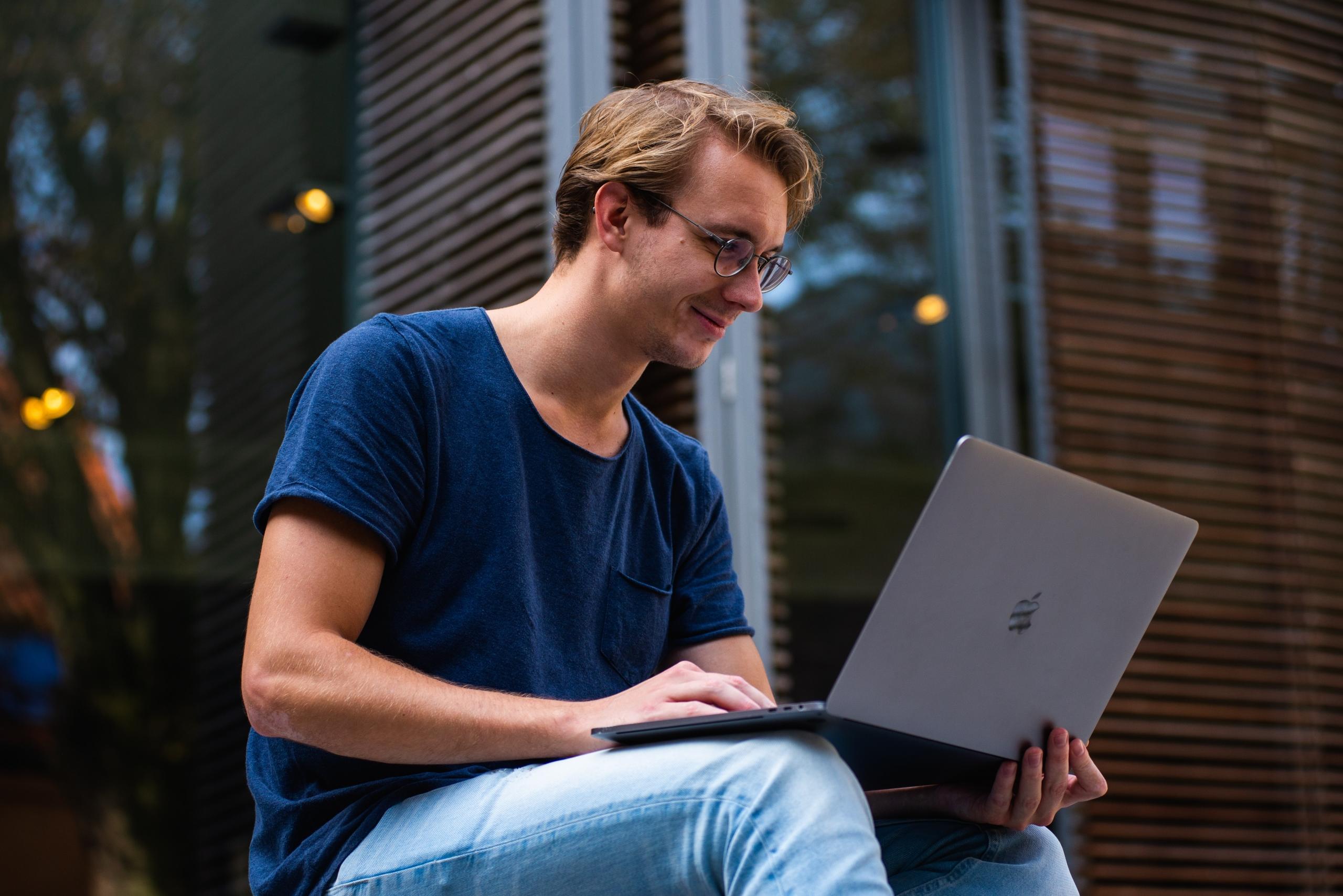 An adult student works on a laptop