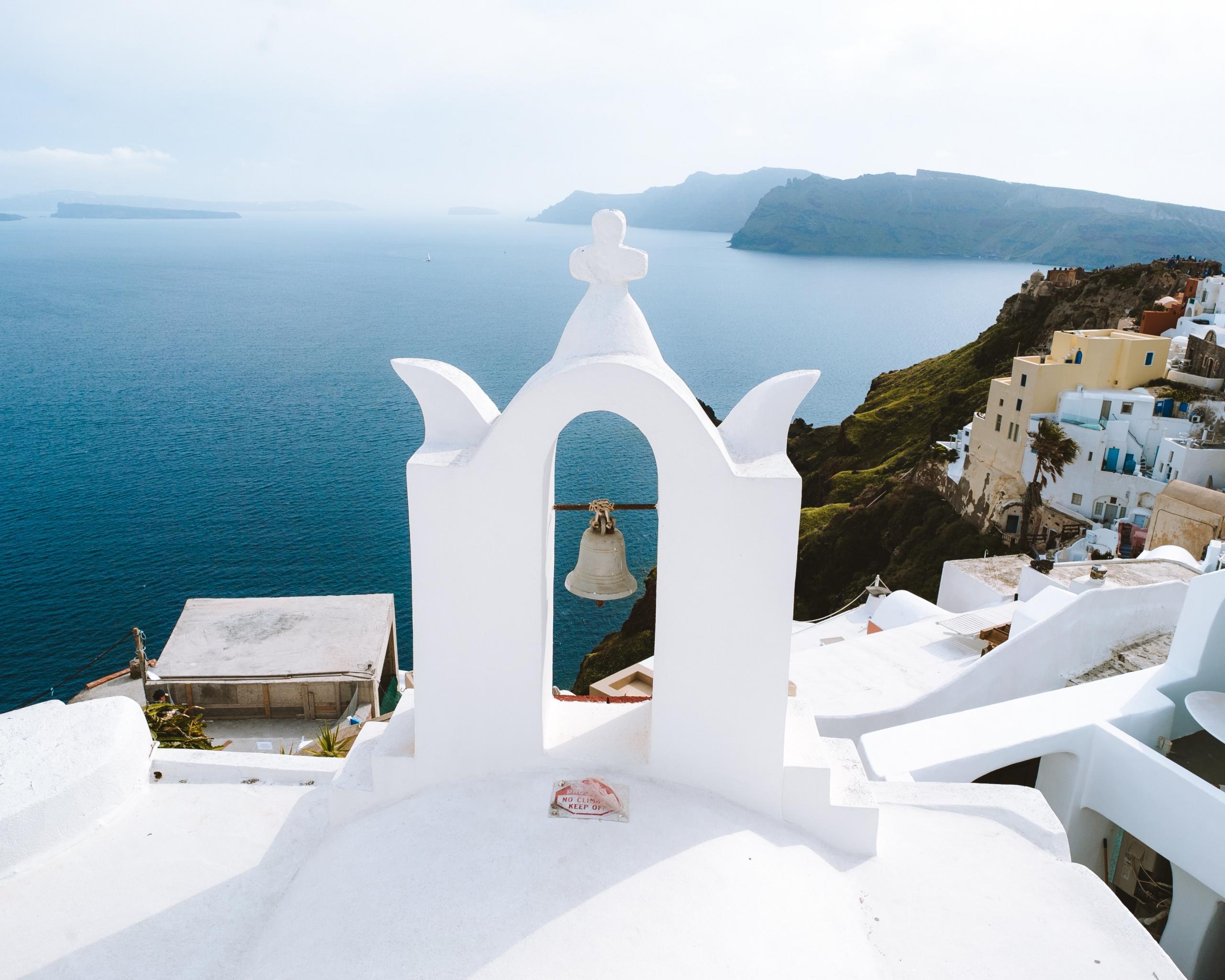 A white building overlooks the coast.