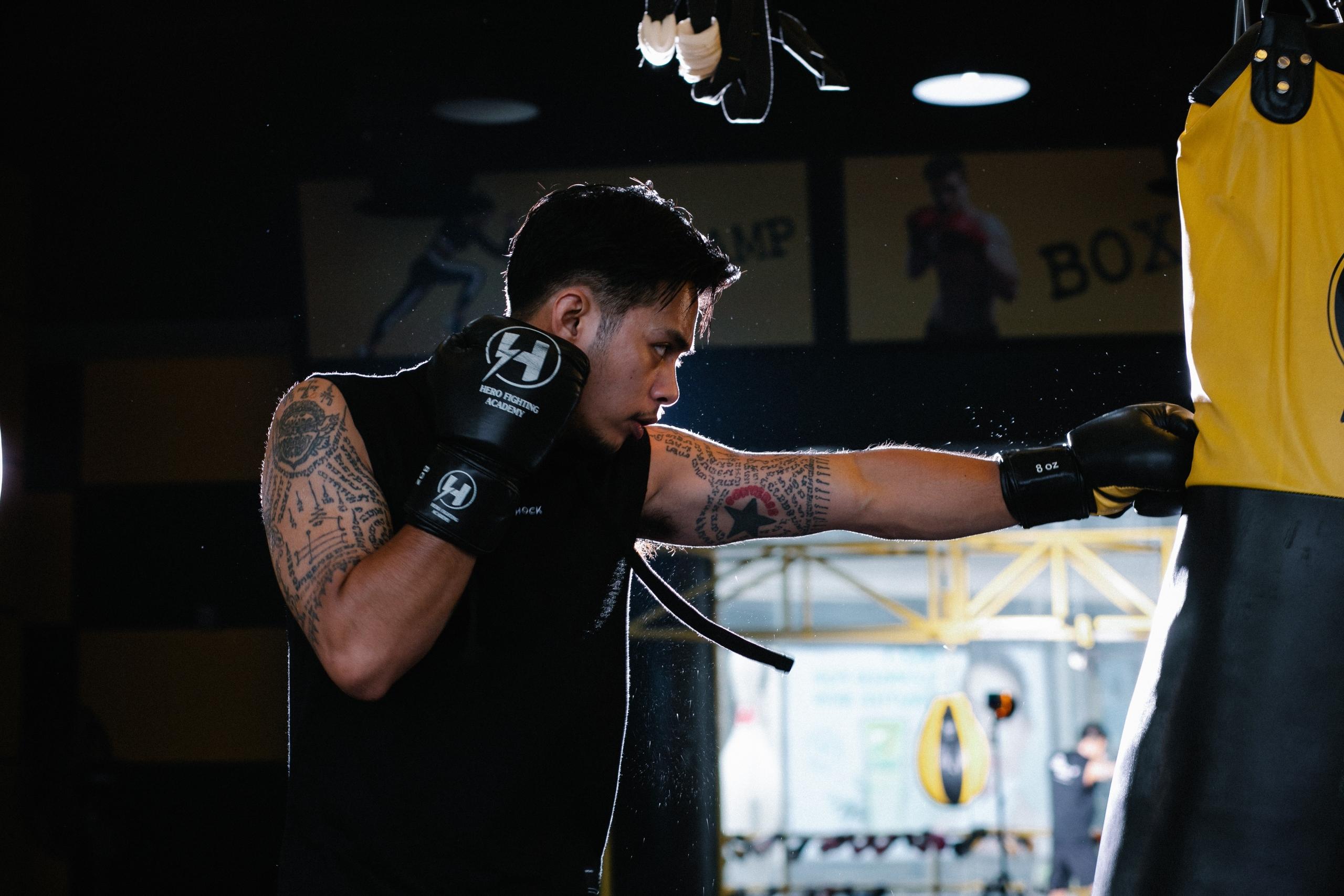a boxing athlete trains with a punching bag.