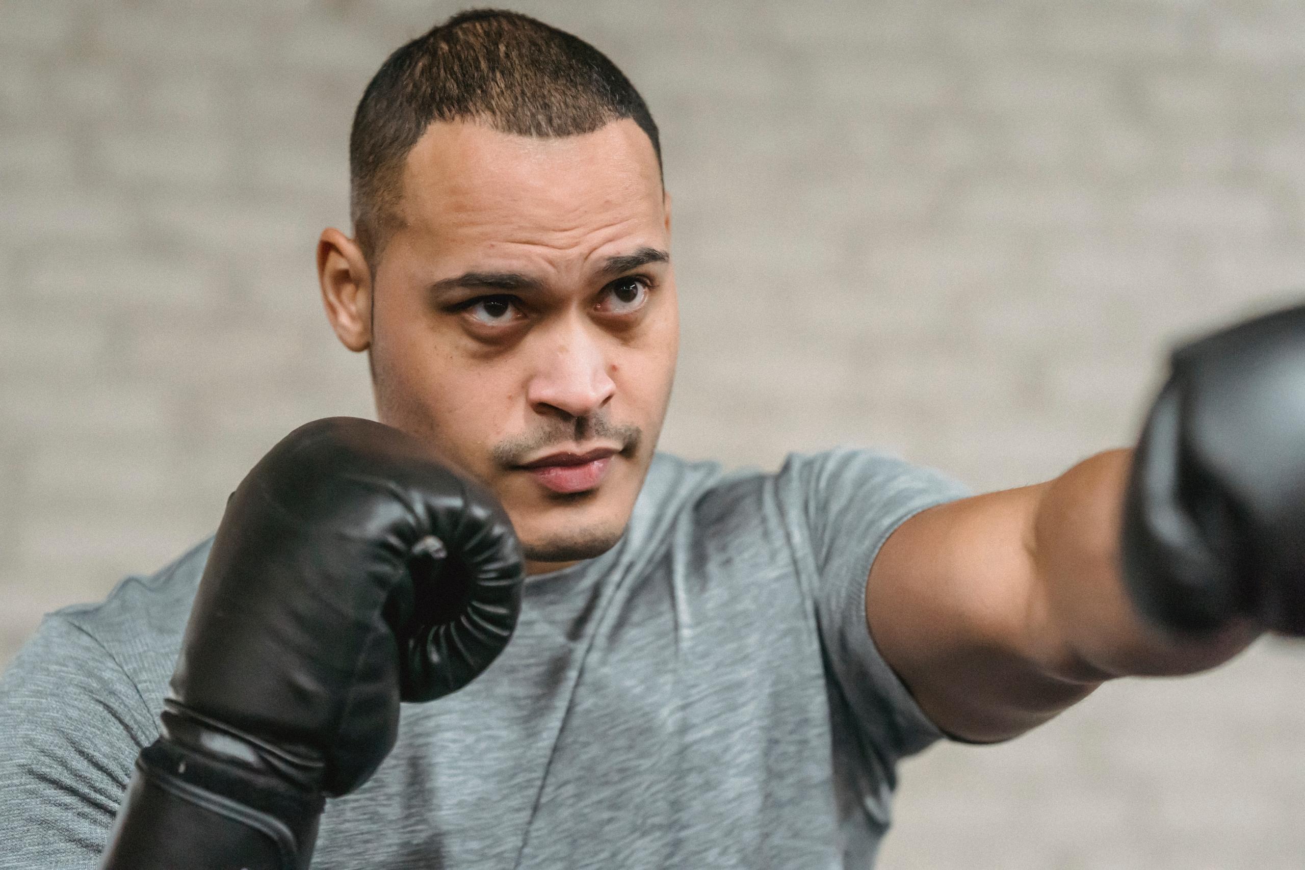 a man boxes with black gloves.