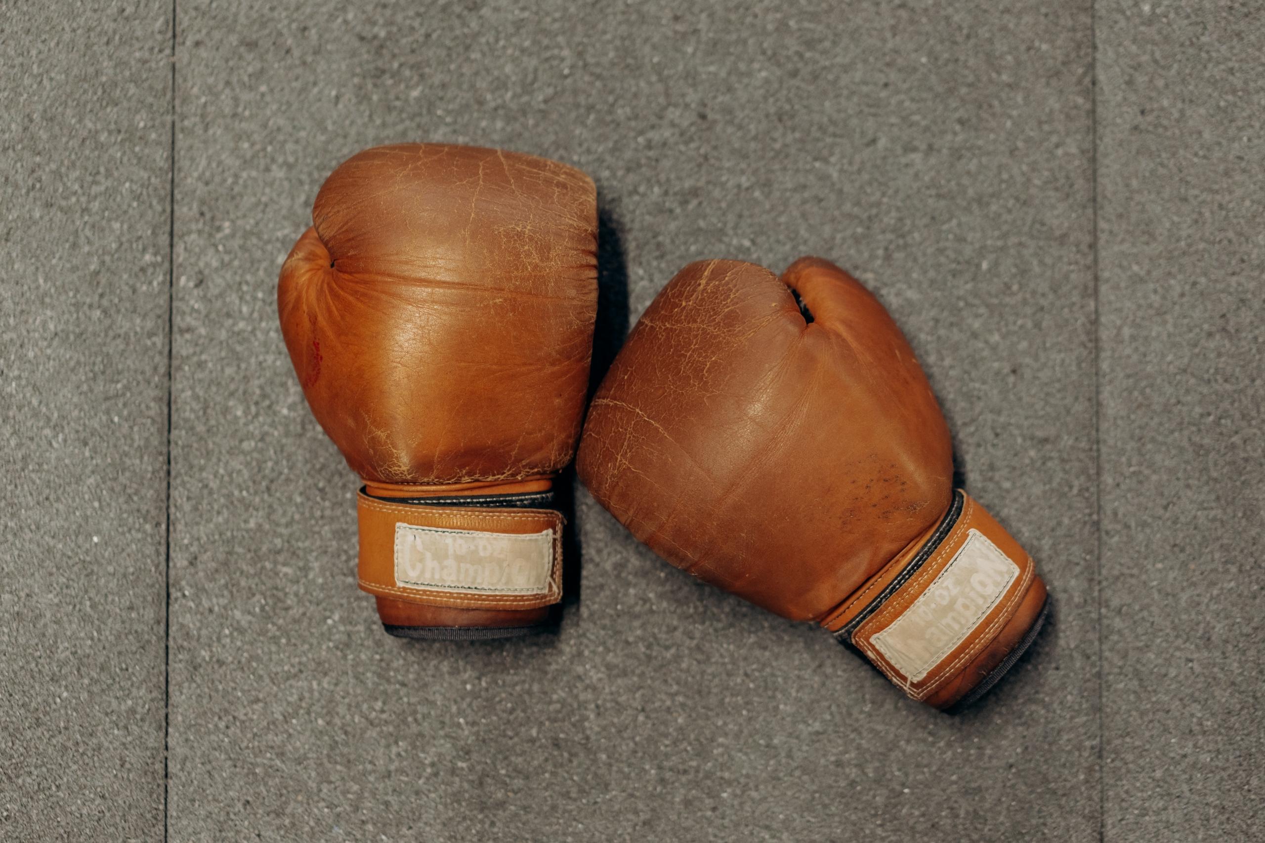 a pair of brown leather boxing gloves.