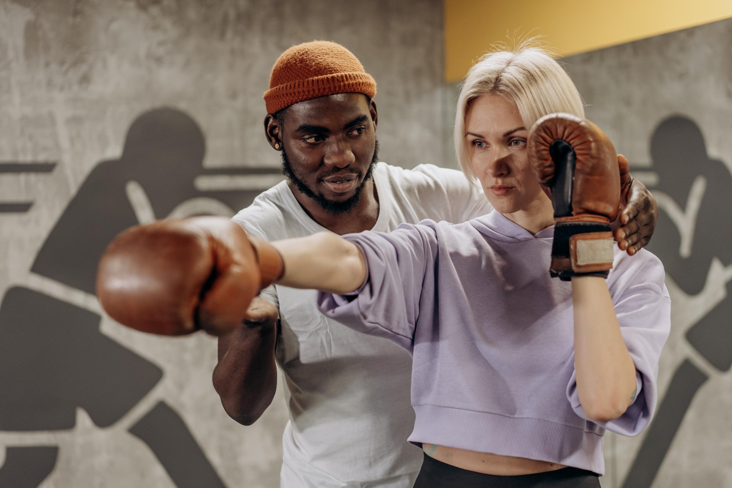 A man trains a woman boxer.