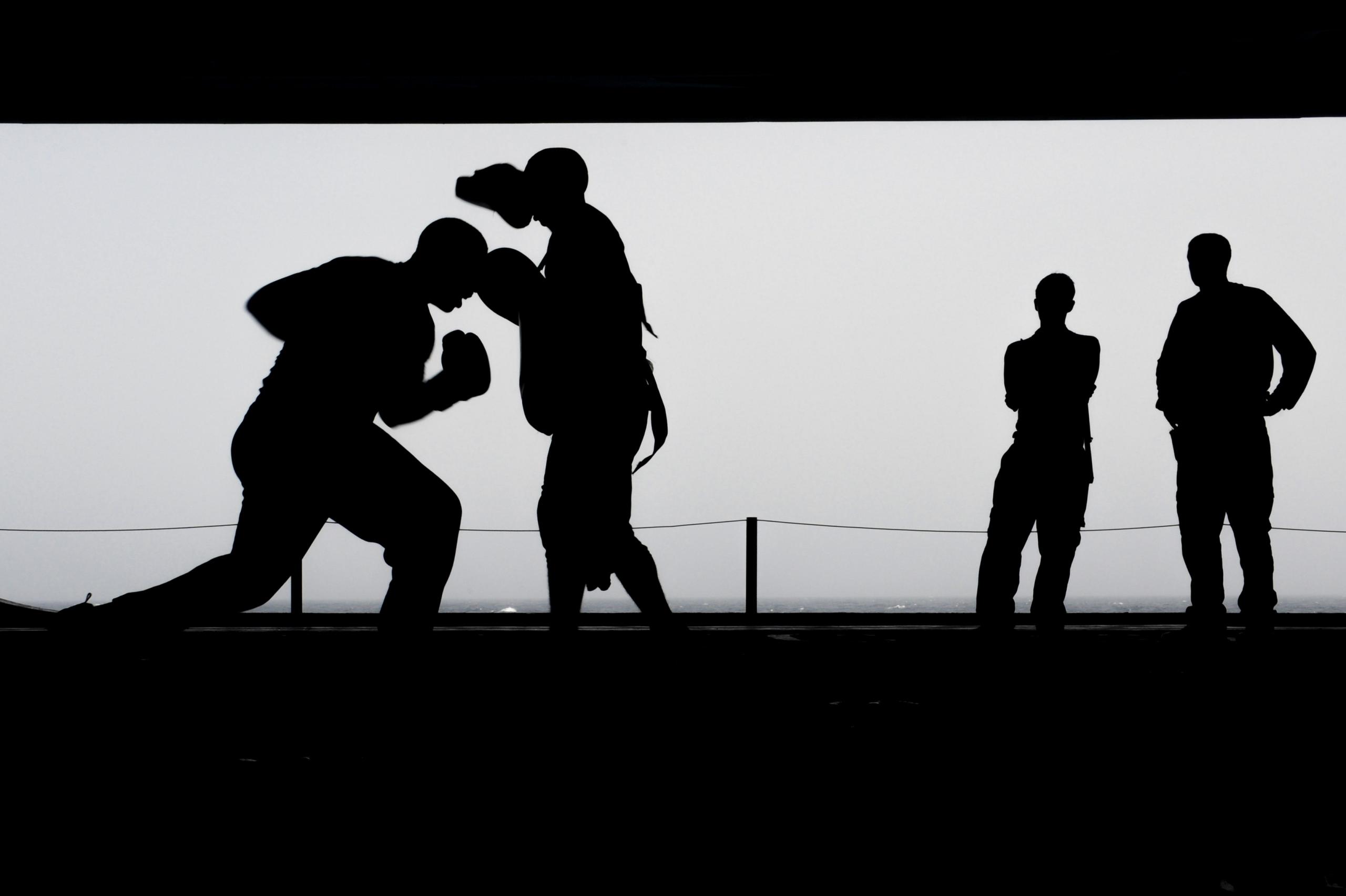 Boxers train in an open space.