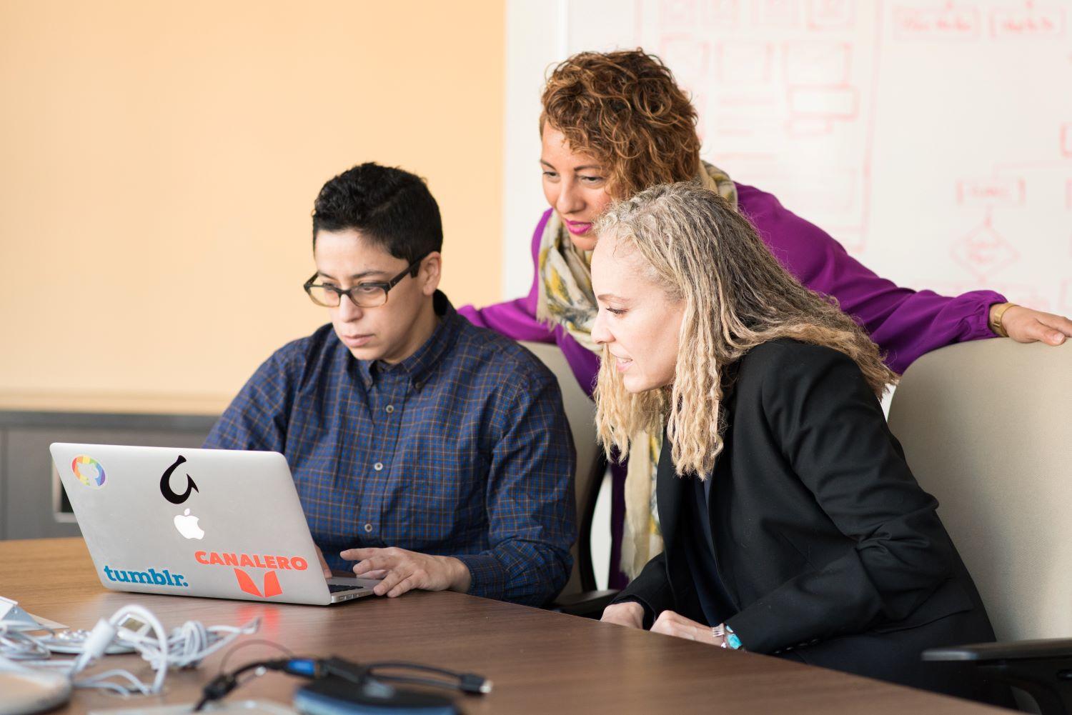 People looking at a laptop