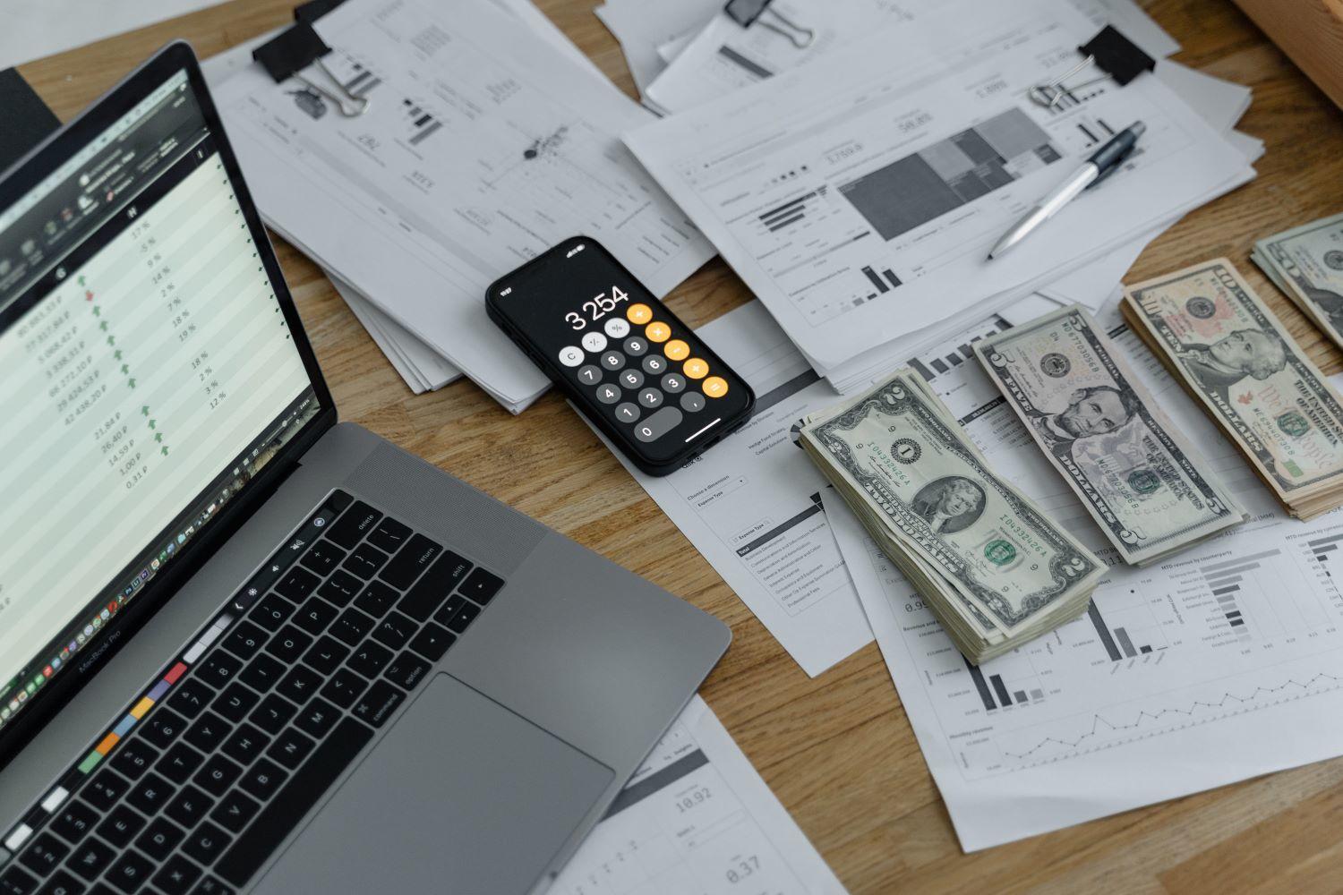 Money and laptop on a table