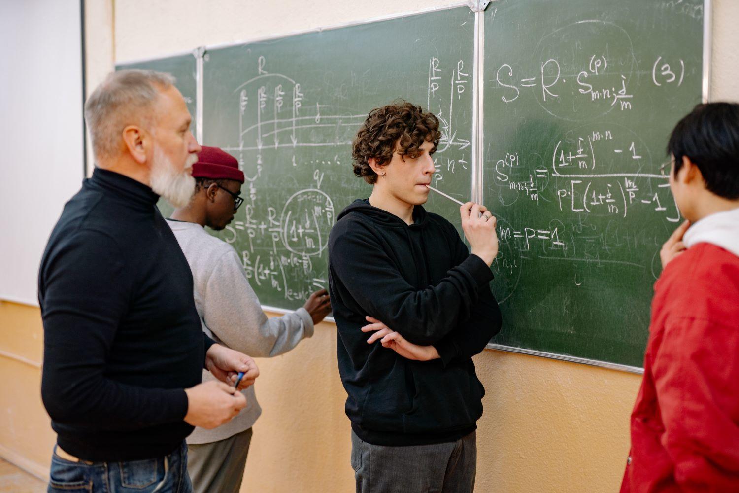 Man writing on the black board