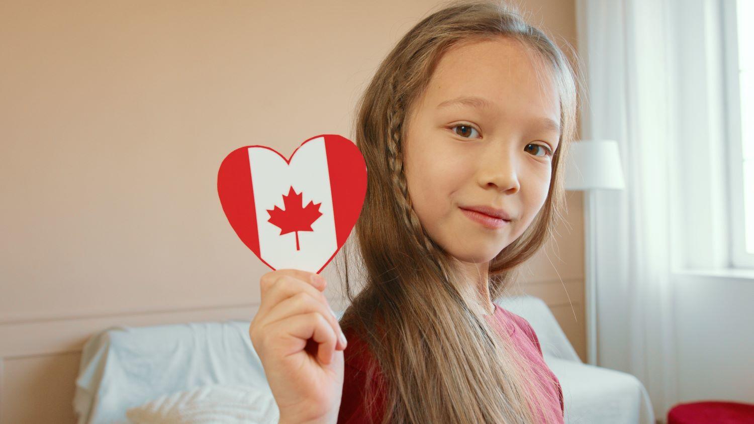 A girl holding a paper heart