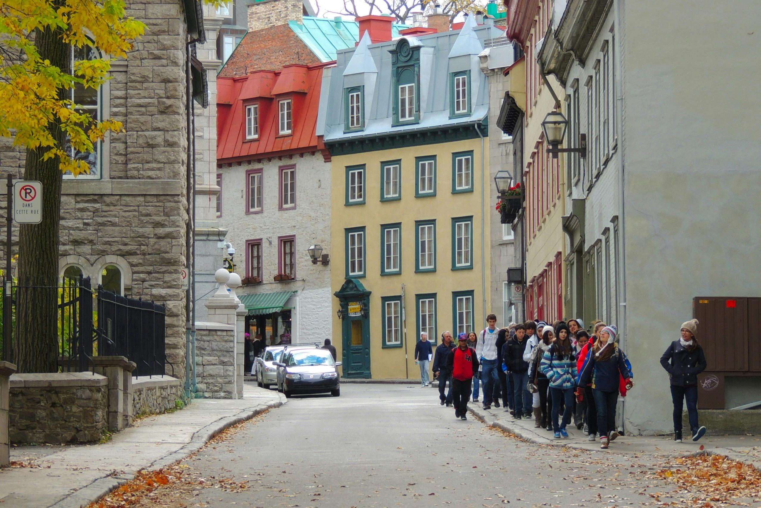 A group of people walk through the streets of Quebec City.