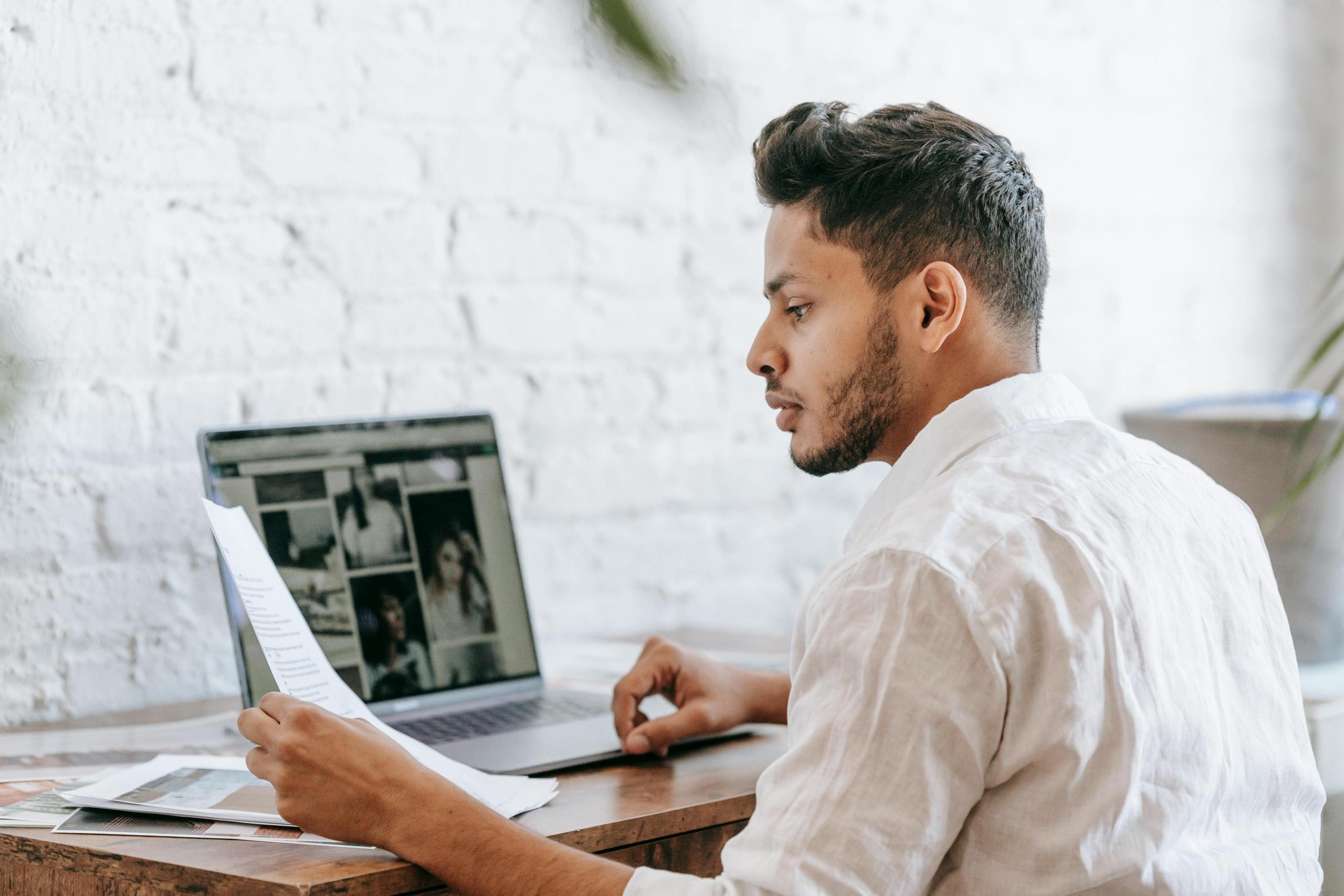 a man works in front of a computer to code