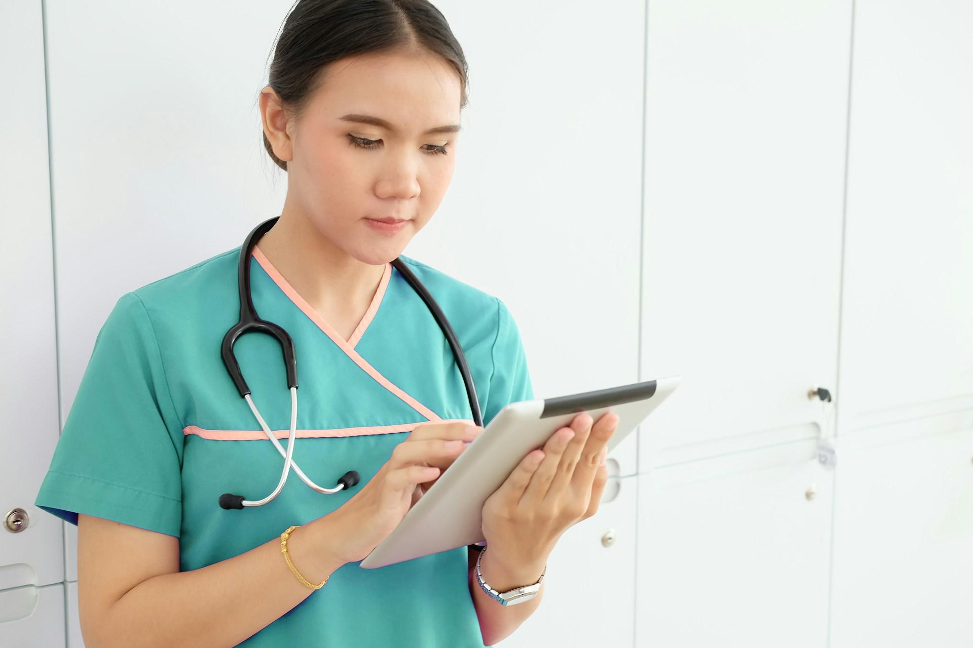 A nurse charting on an Ipad.