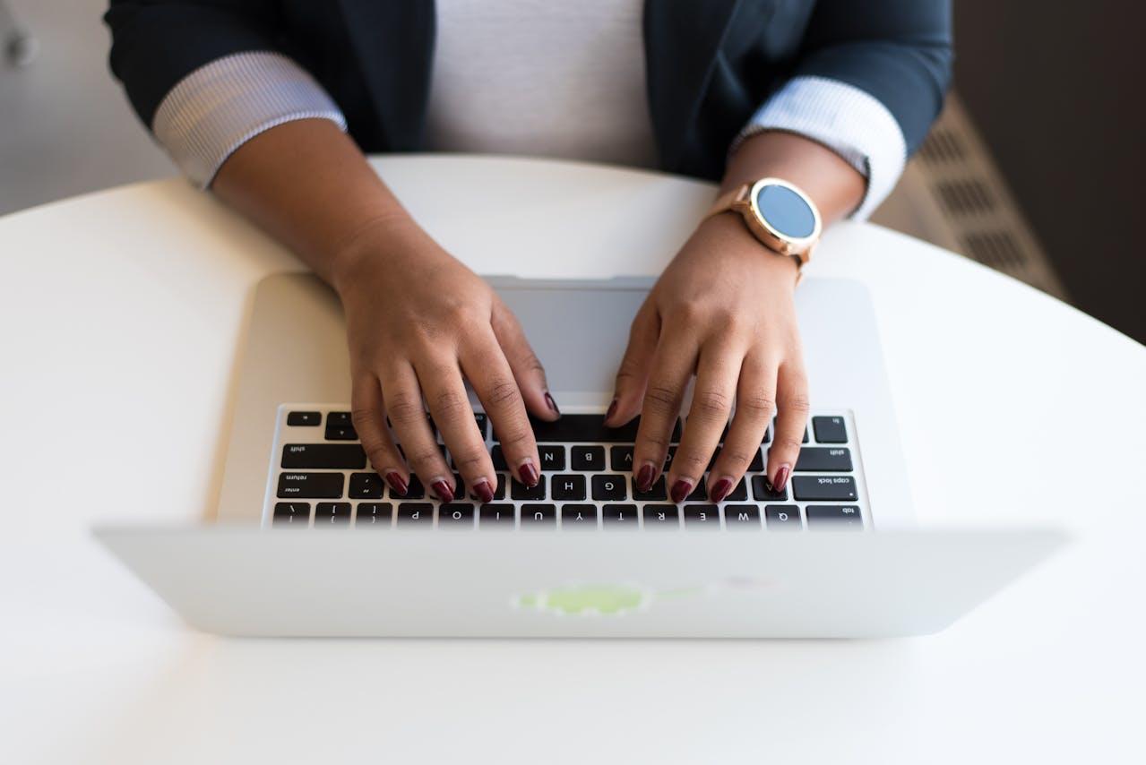 A student nurse writing her NCLEX exam on a computer.