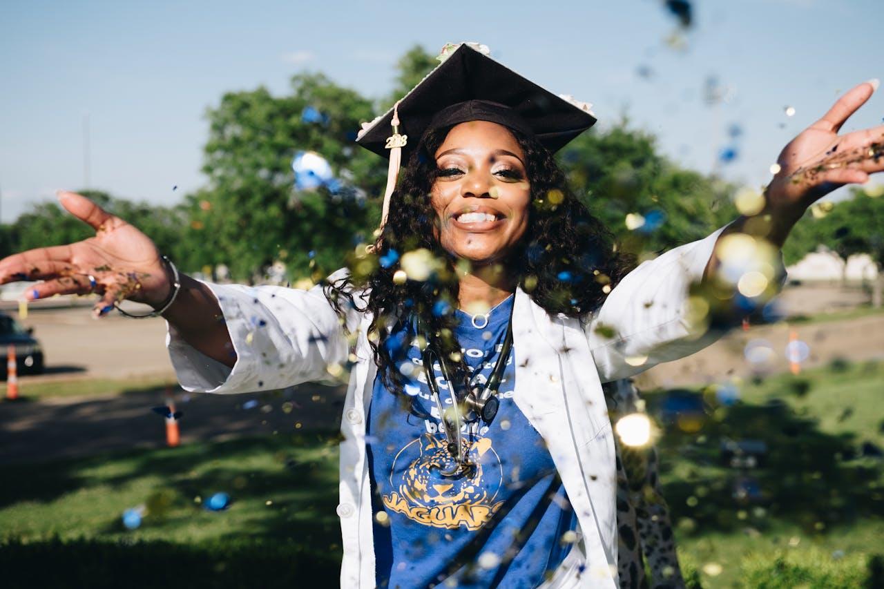 A nurse graduate celebrating with confetti.