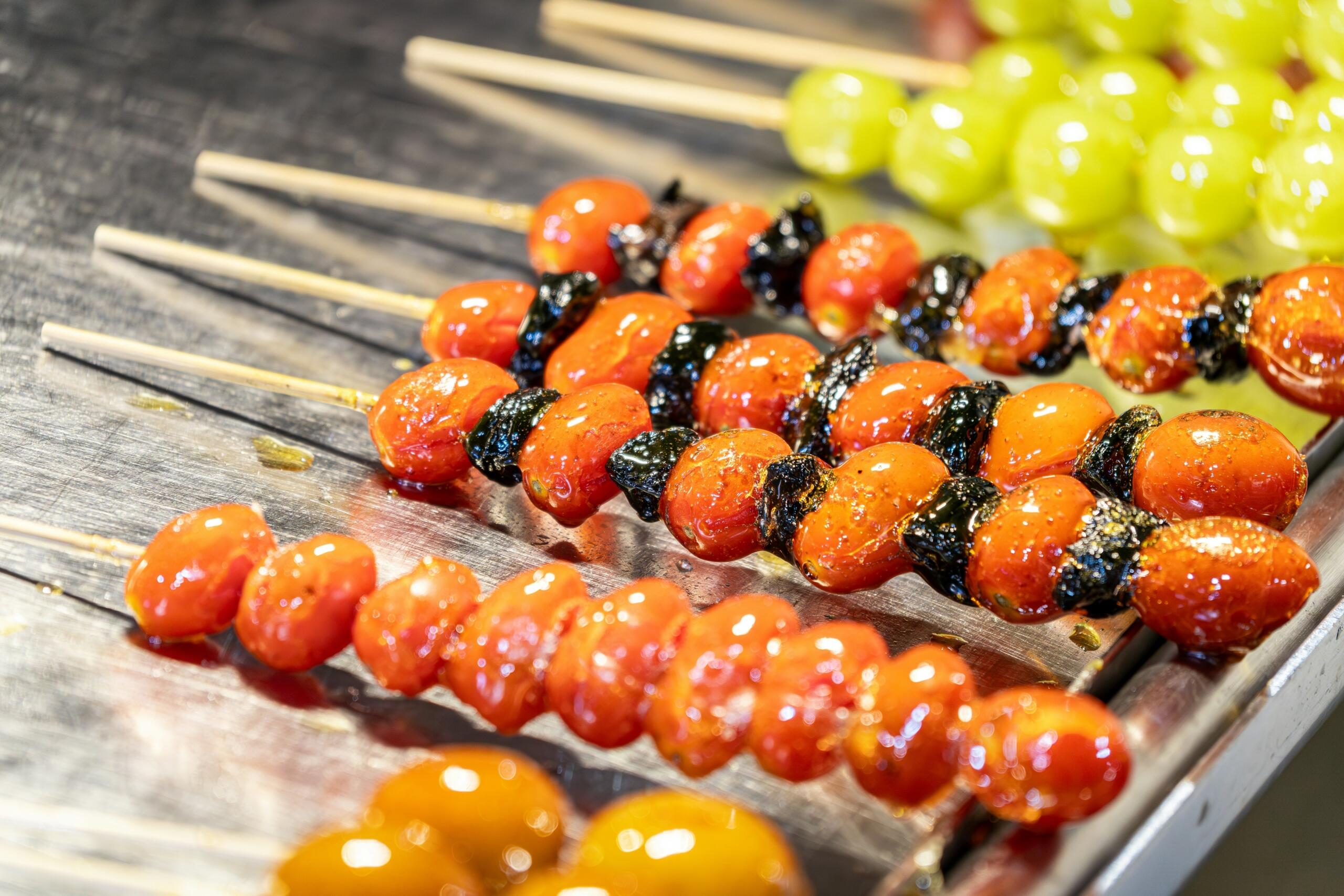 A collection of skewers adorned with an array of colorful tomatoes, highlighting their diverse hues and shapes.