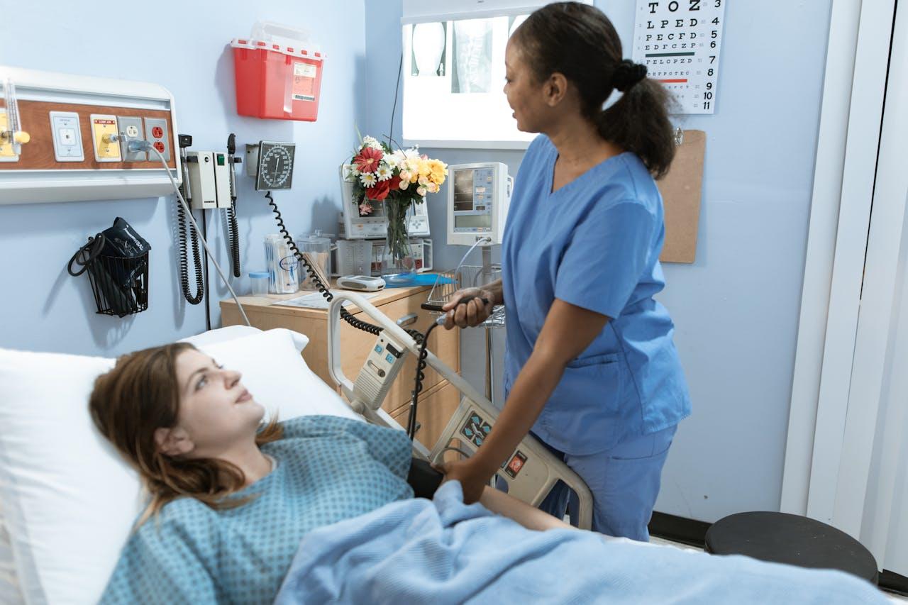 A nurse working along the bedside of a patient.
