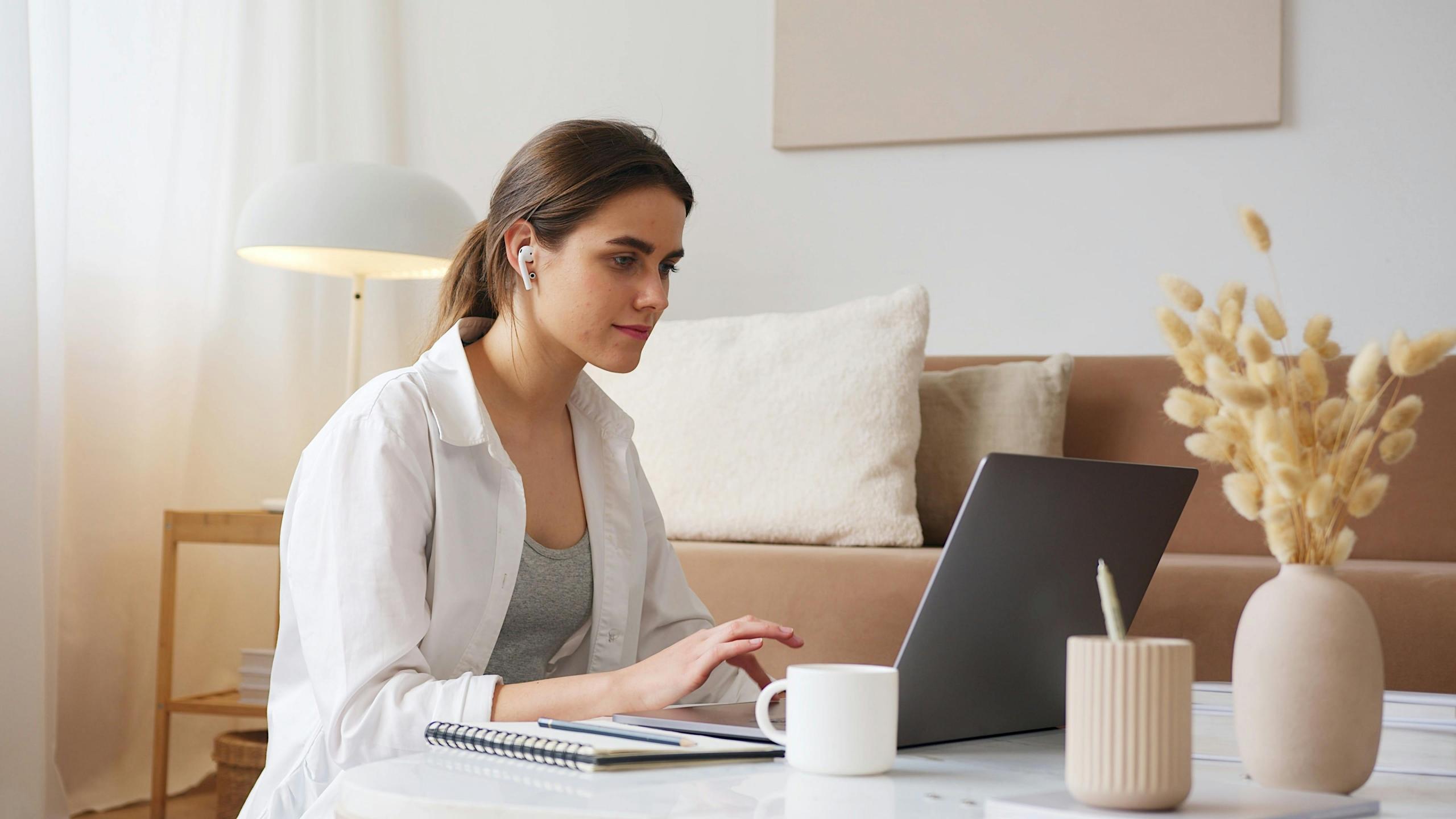 a woman studies at her computer.