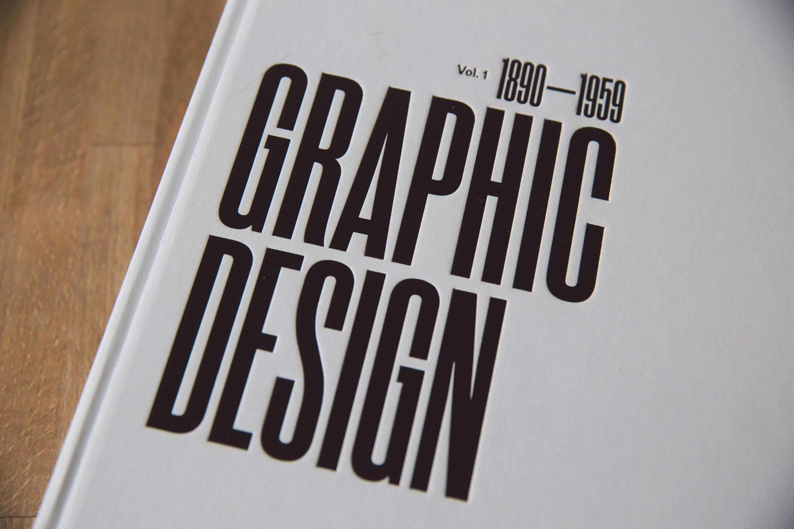A graphic design from 1890-1959 book on a table.