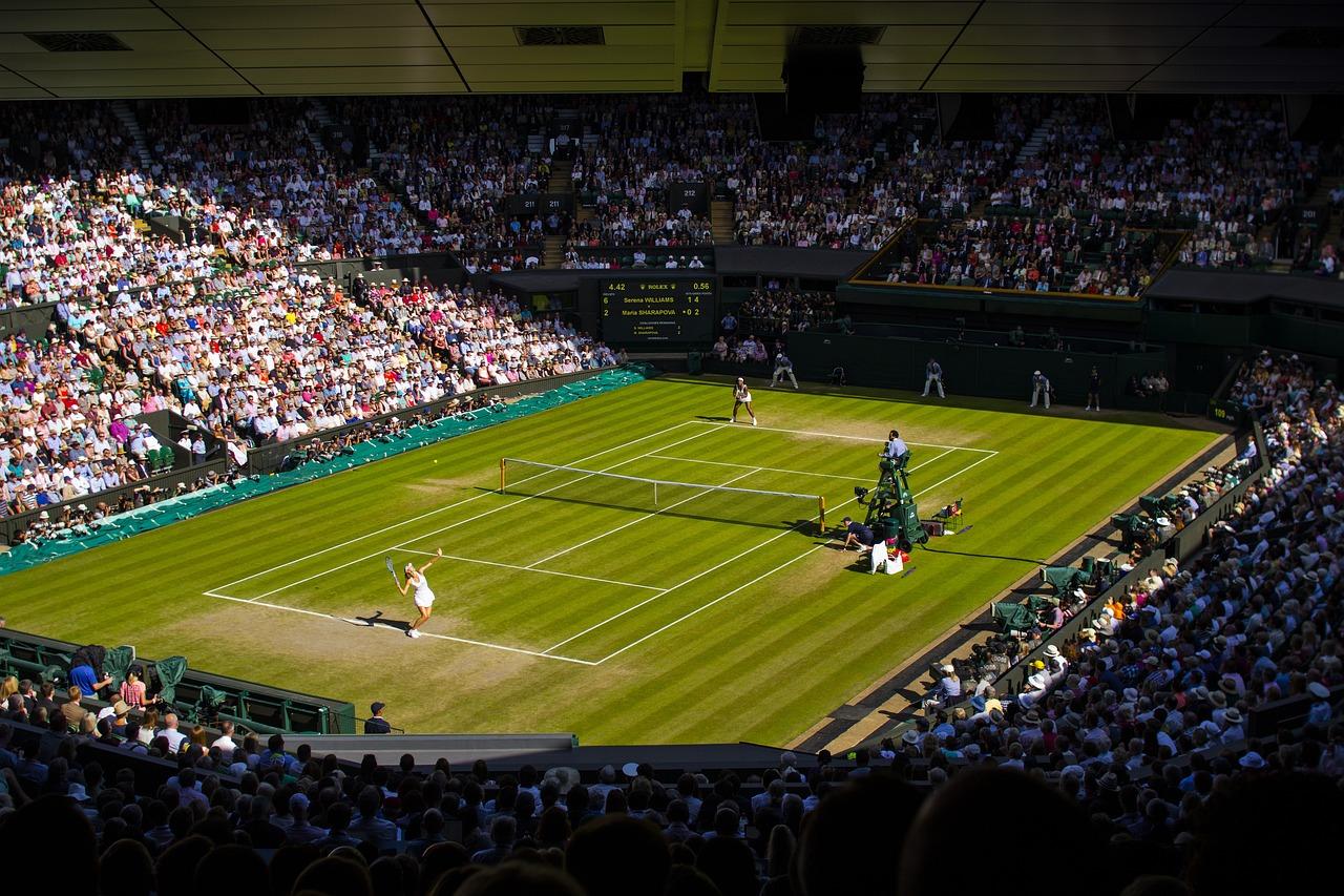 Woman Wimbledon match with a full audience.