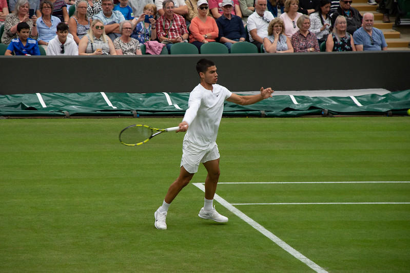 Alcaraz playing one of his famous tennis matches.