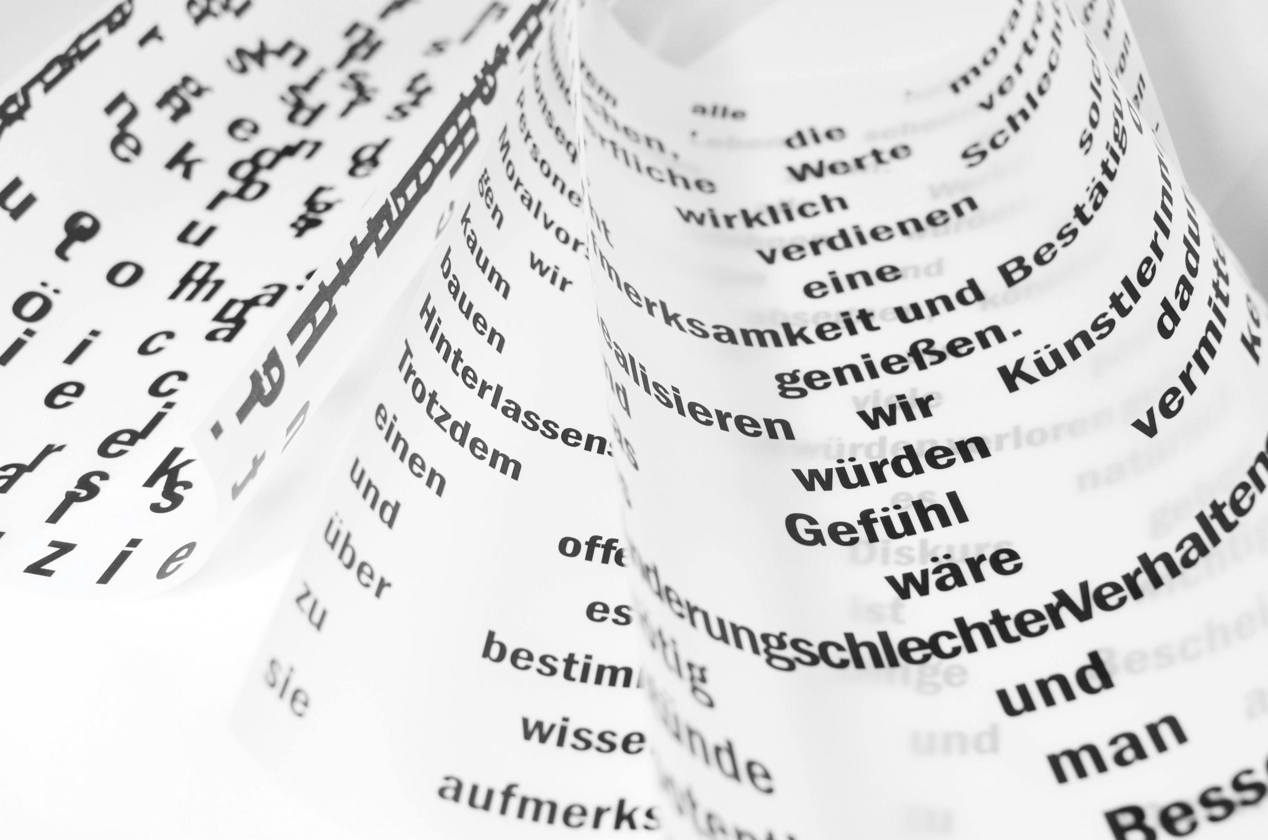 2 pieces of paper with german words on it.