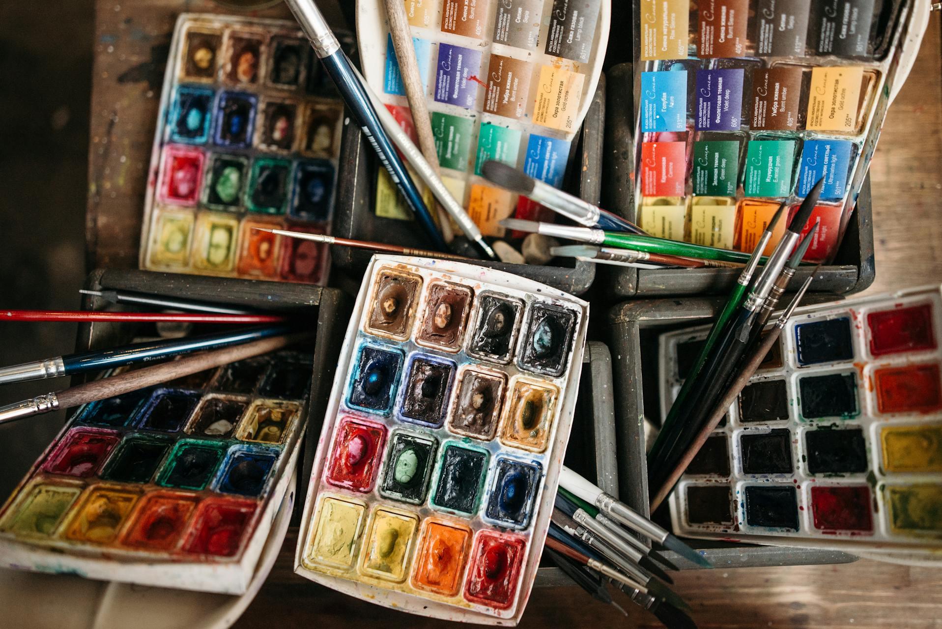 Boxes of watercolors and brushes after art class.