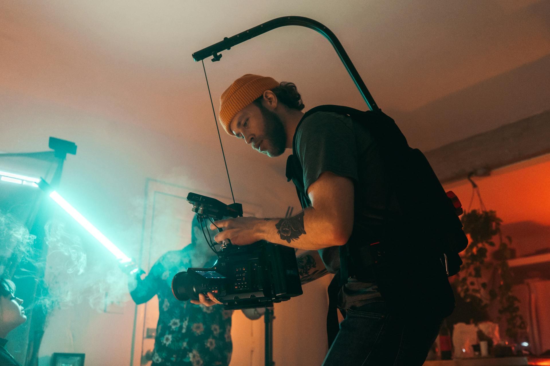 Man holding a video camera on set