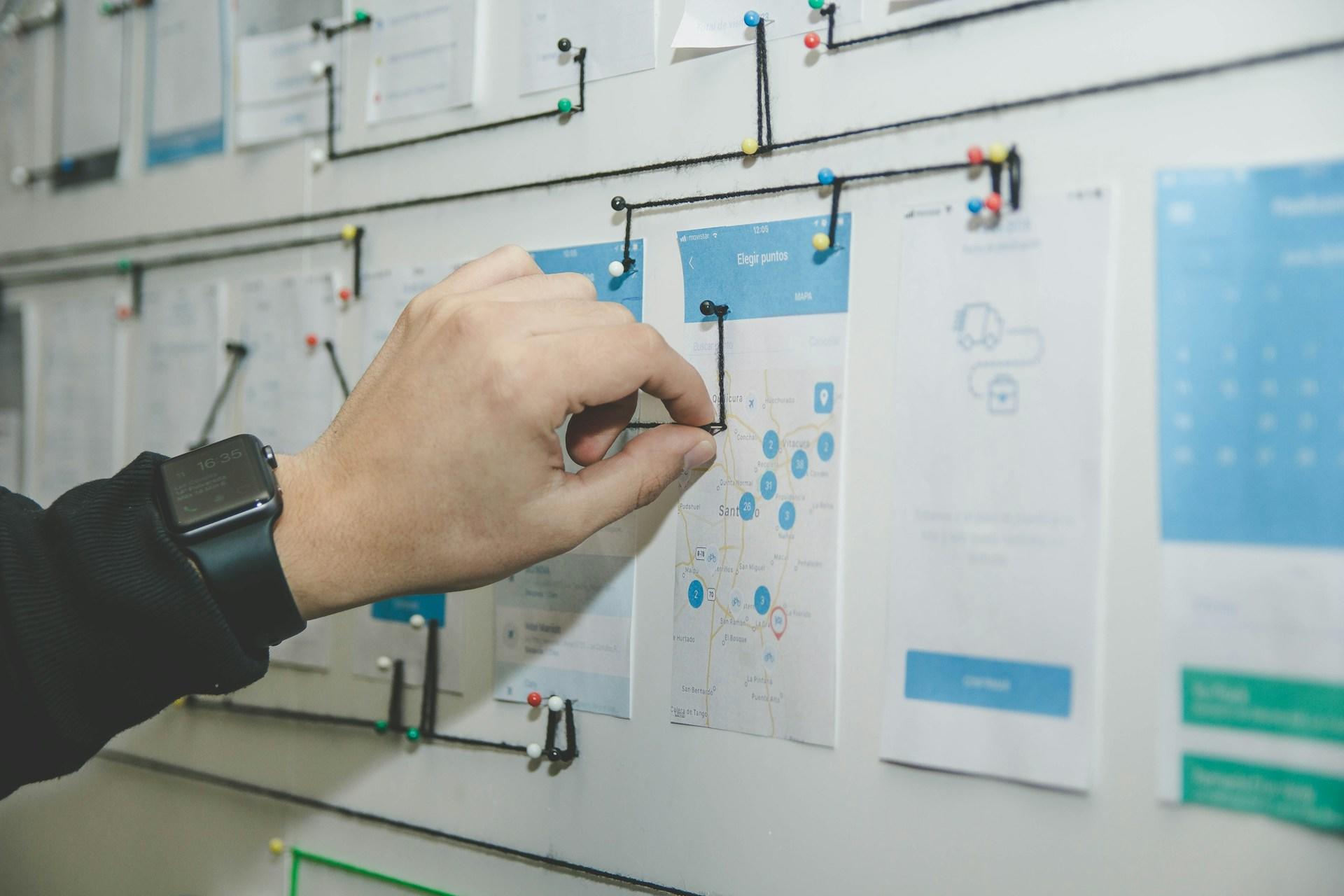 Pictures of the design of an app on a board, for a graphic design project.