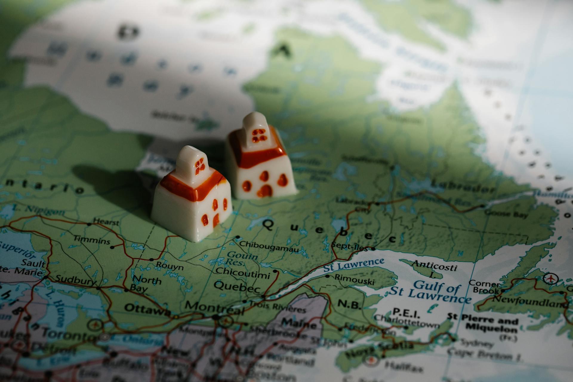 Two porcelain houses on top of a Quebec map