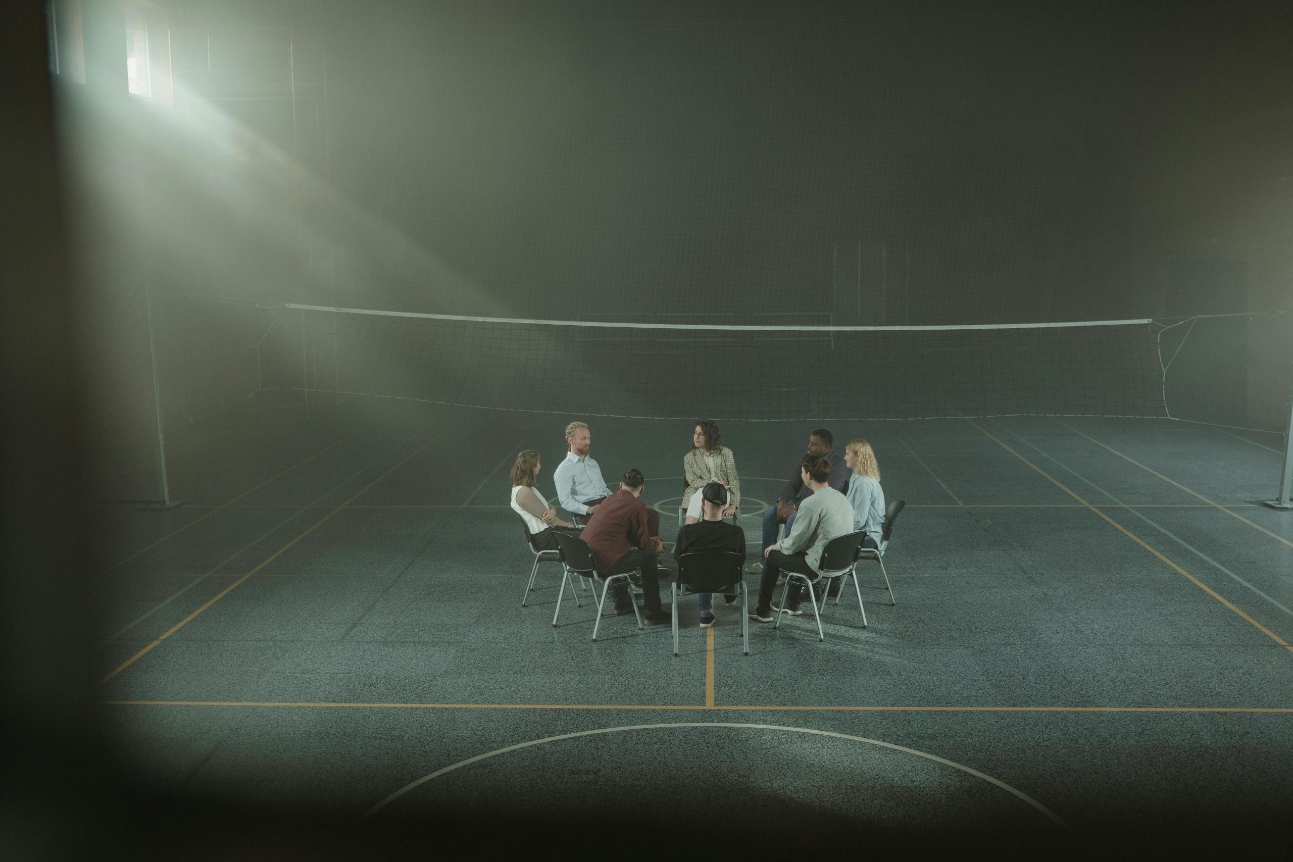 A group of people sitting together in a quiet room. 