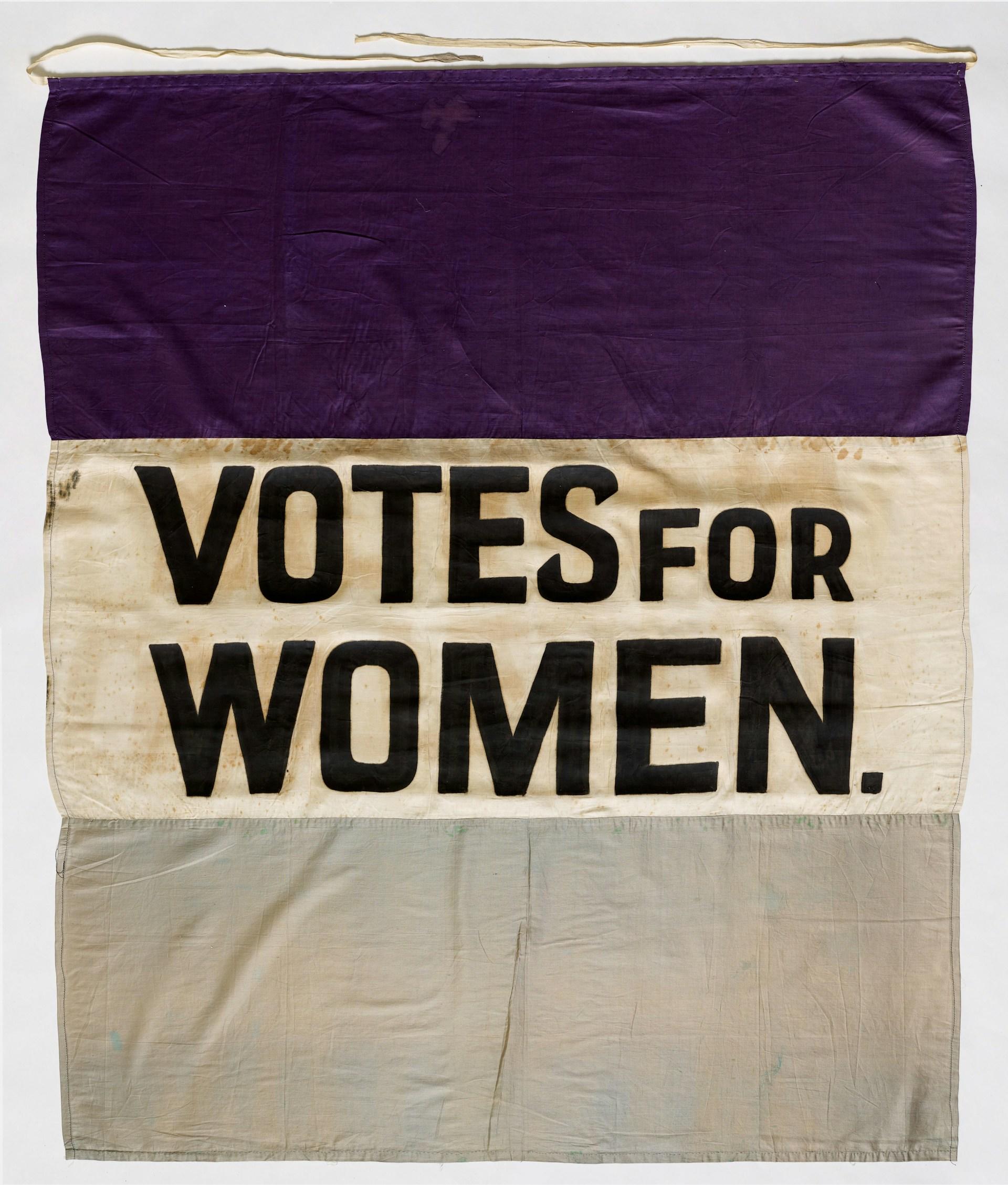 a banner advocating voting rights for women