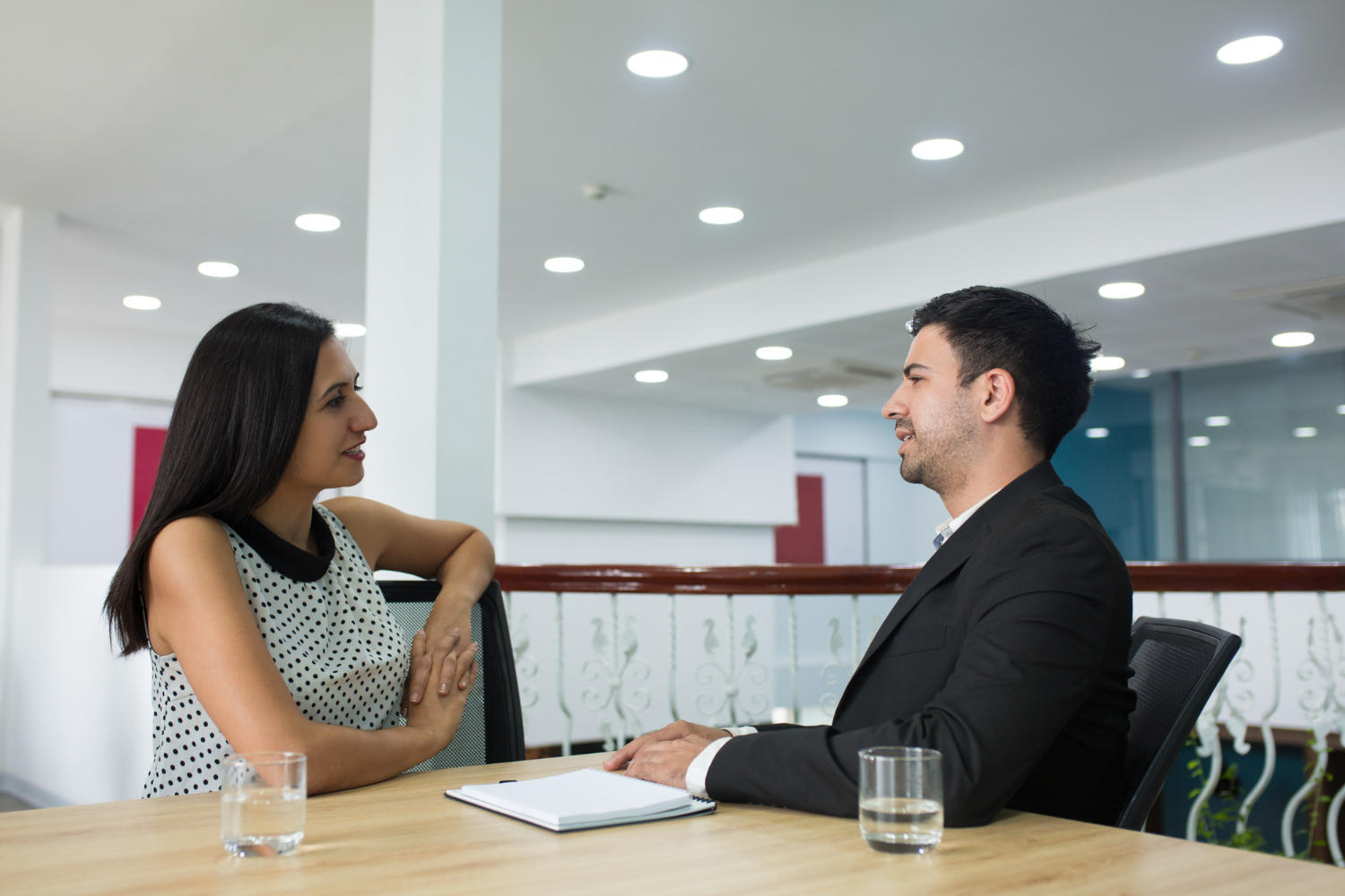 a man and woman talking to each otehr while sitting.