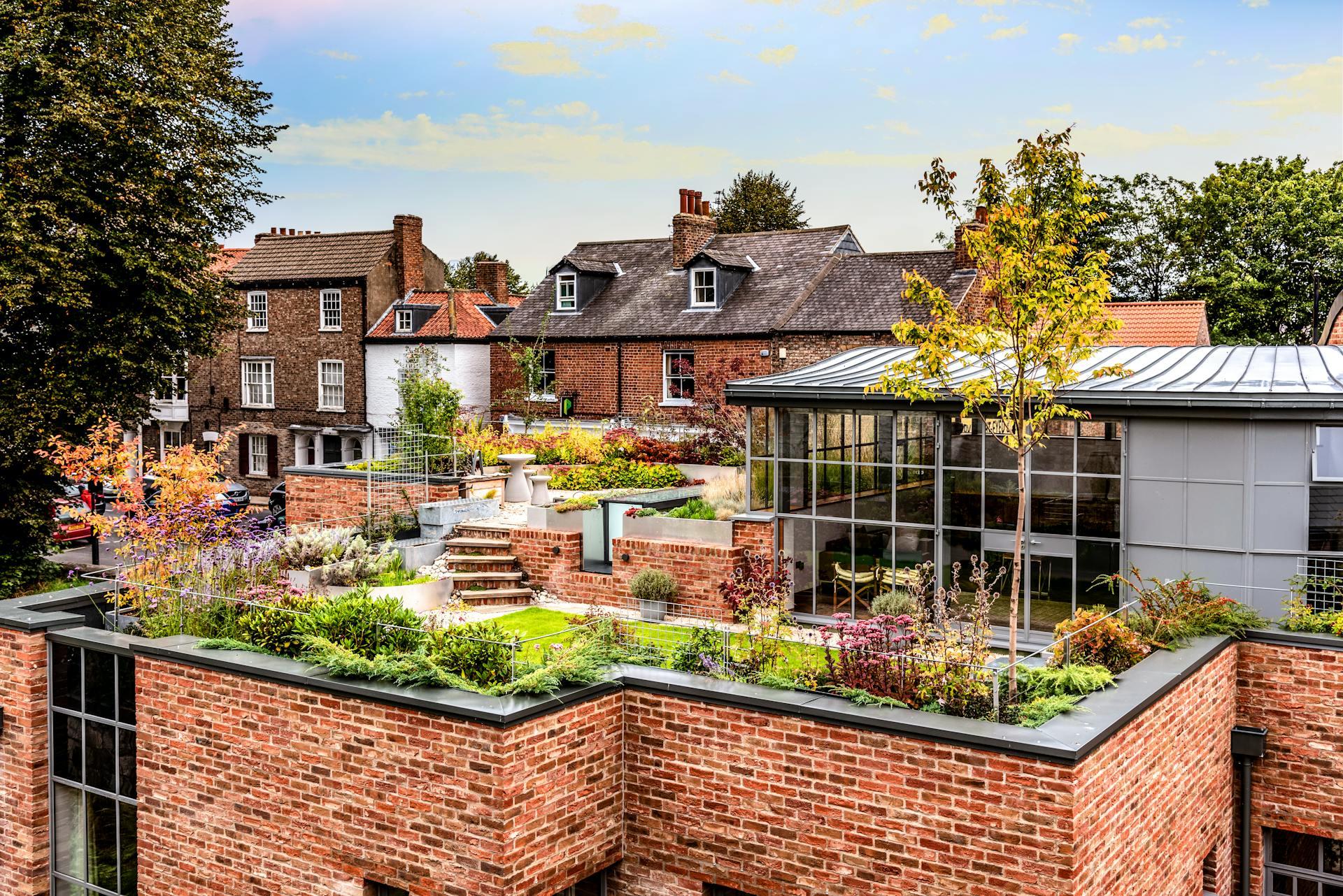 A Garden on the Roof of a Brick Building.