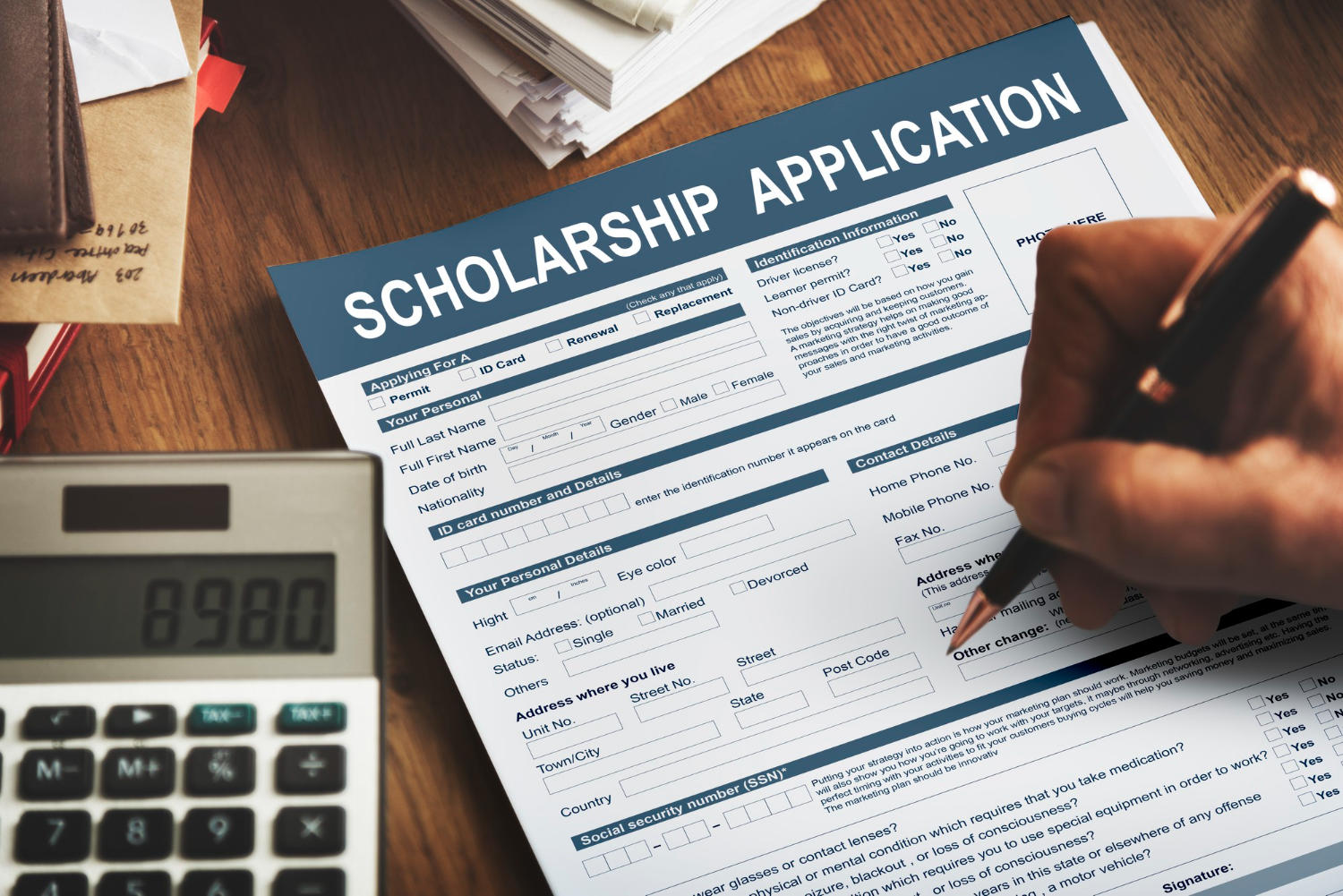 someone filling up a scholarship application form.