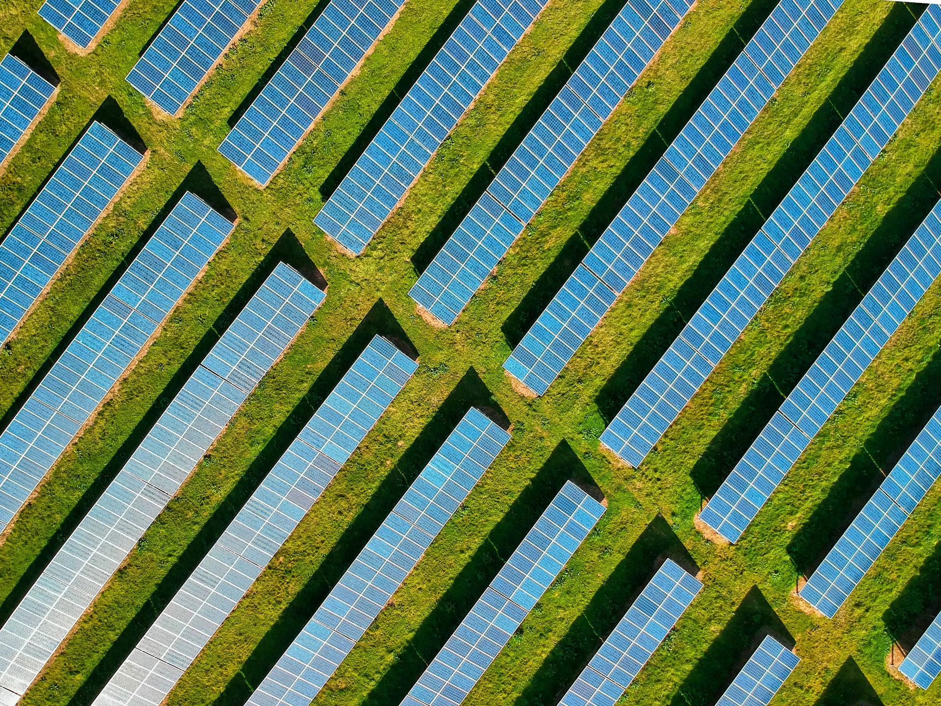 Photograph showing Solar Panels on a Green Field. 