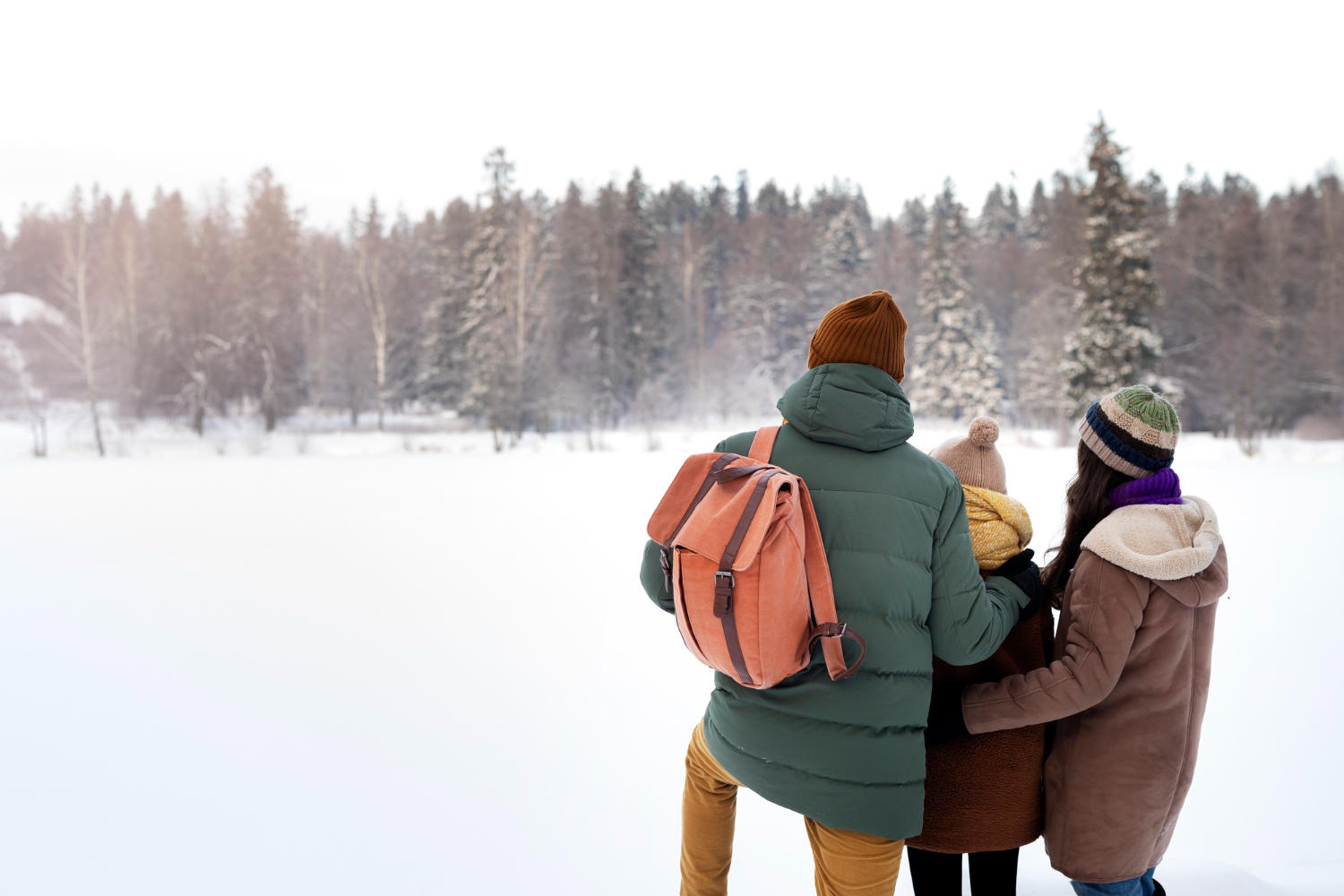 a family looking at snow together.