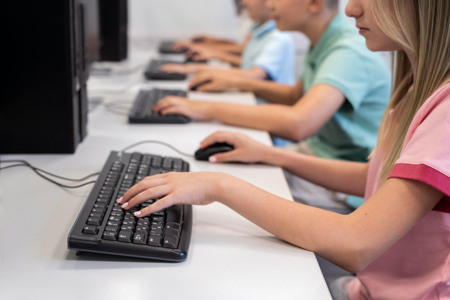 a group of students sitting in front of computers