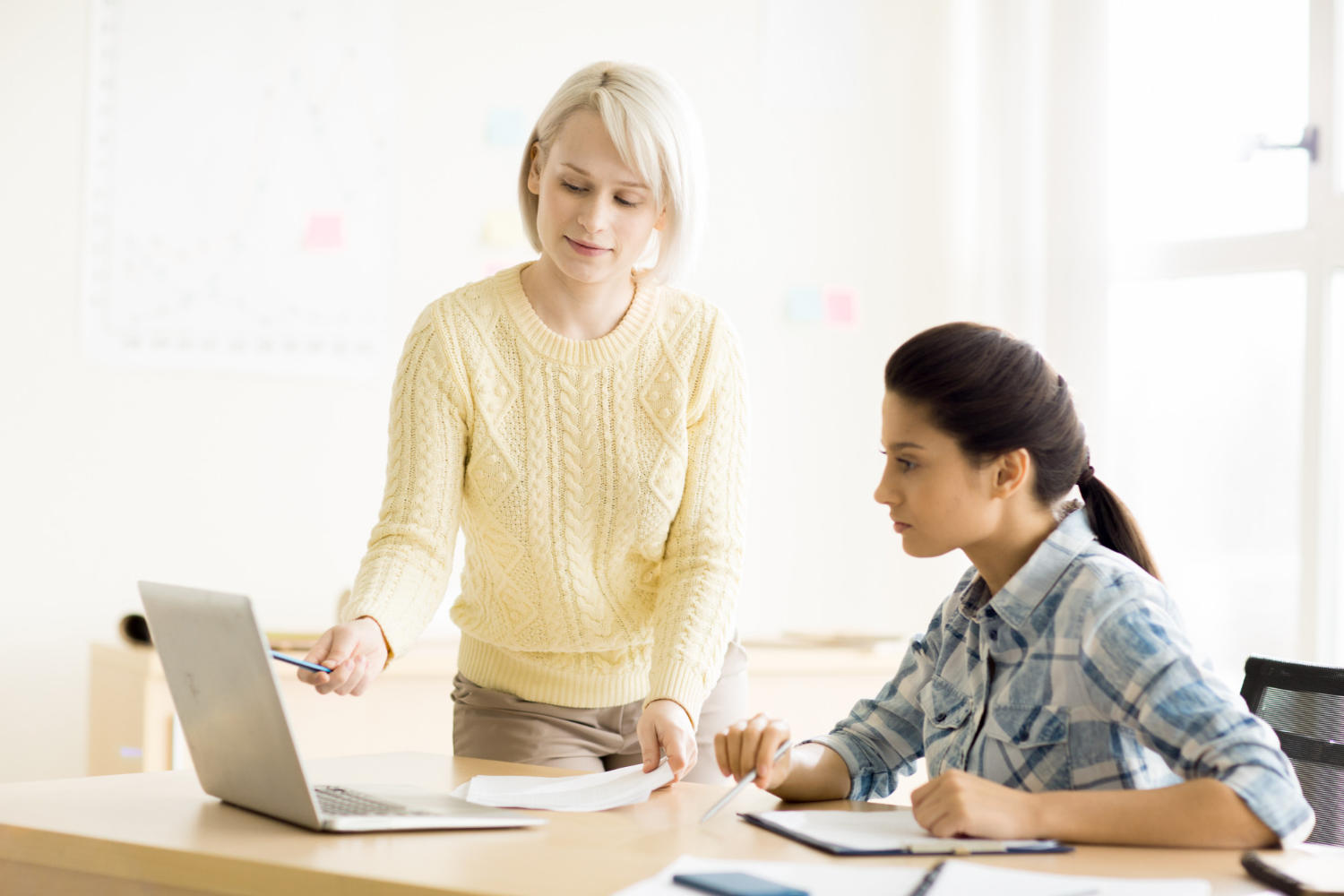 a female tutor teaching a female student.