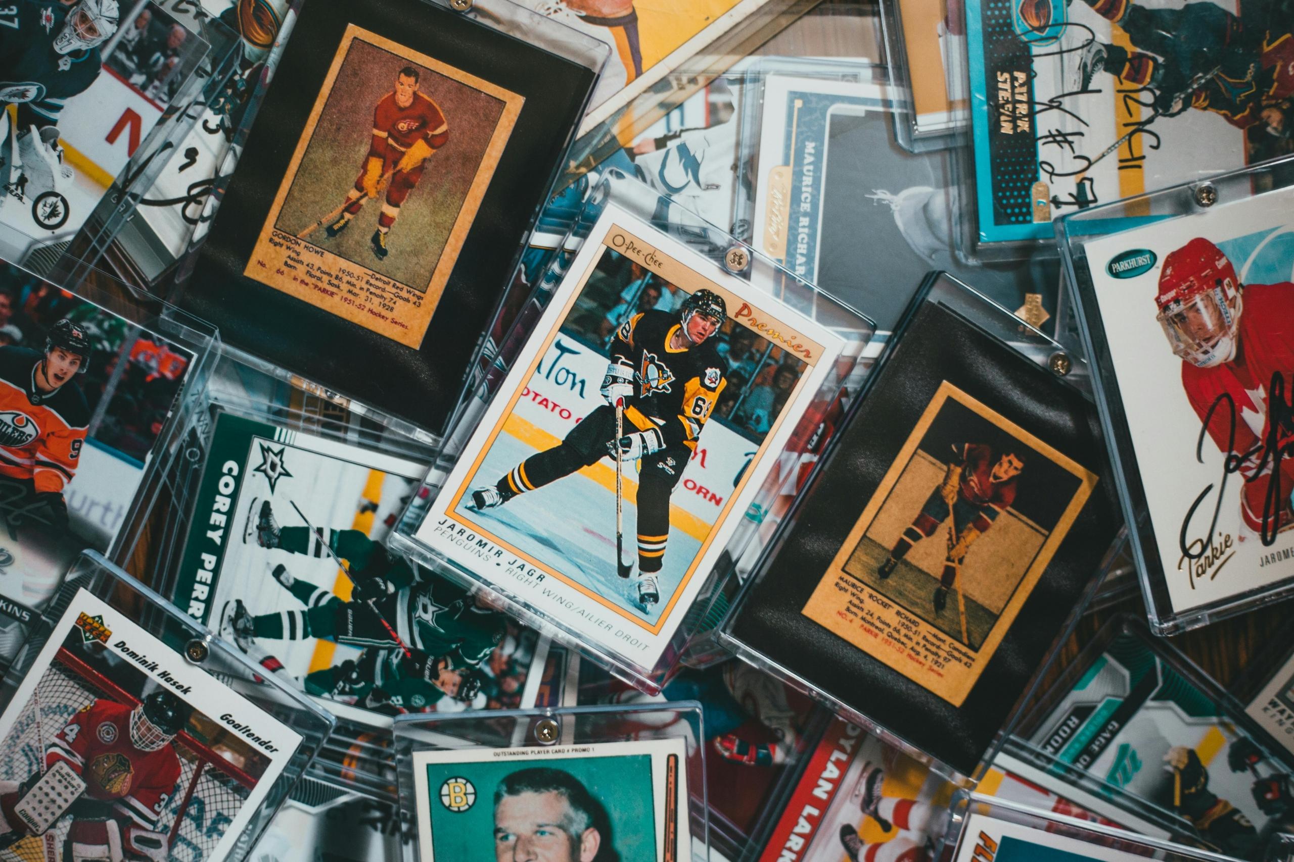 a photo of a mixed up pile of vintage hockey player cards.