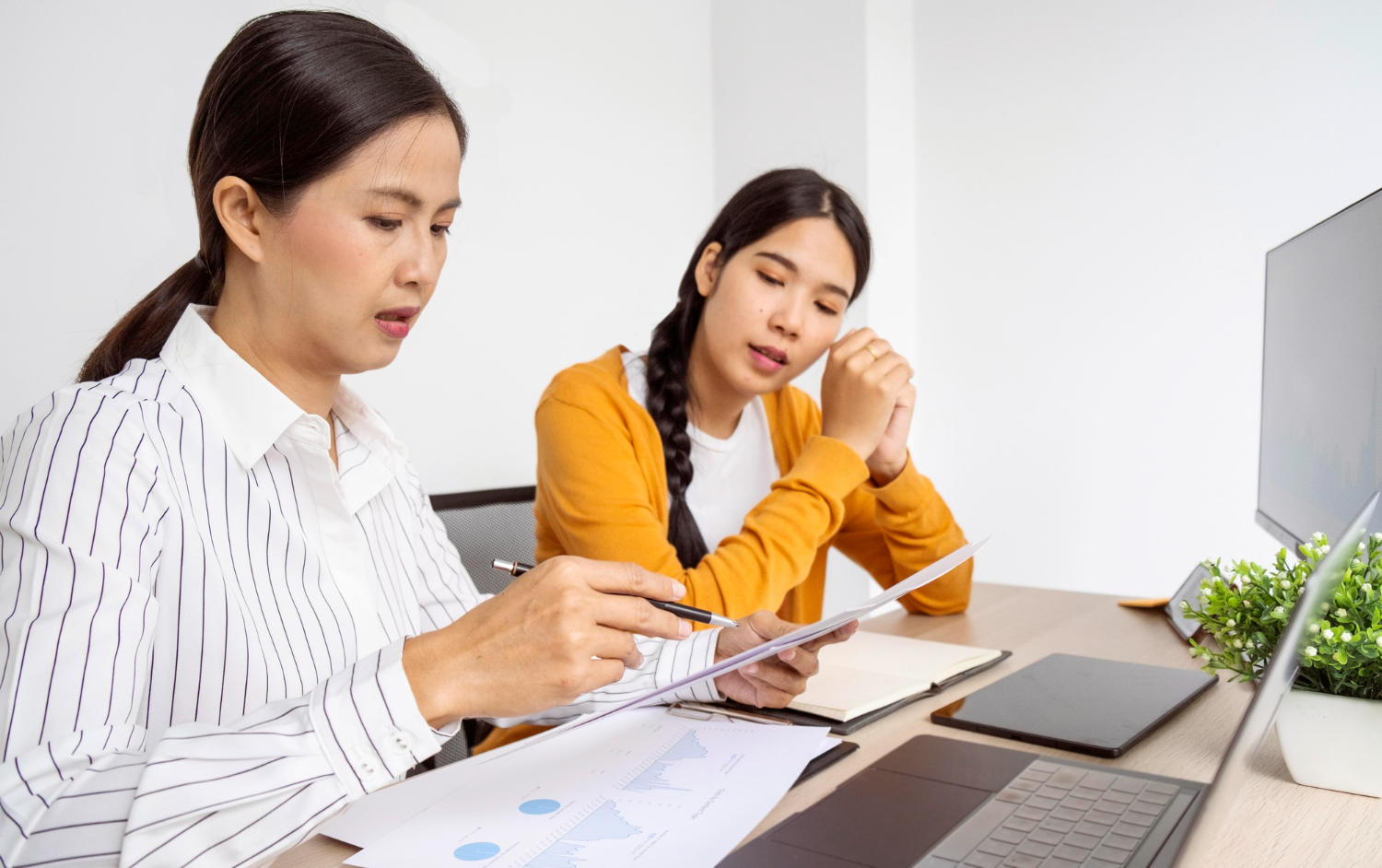 a female tutor teaching a female student