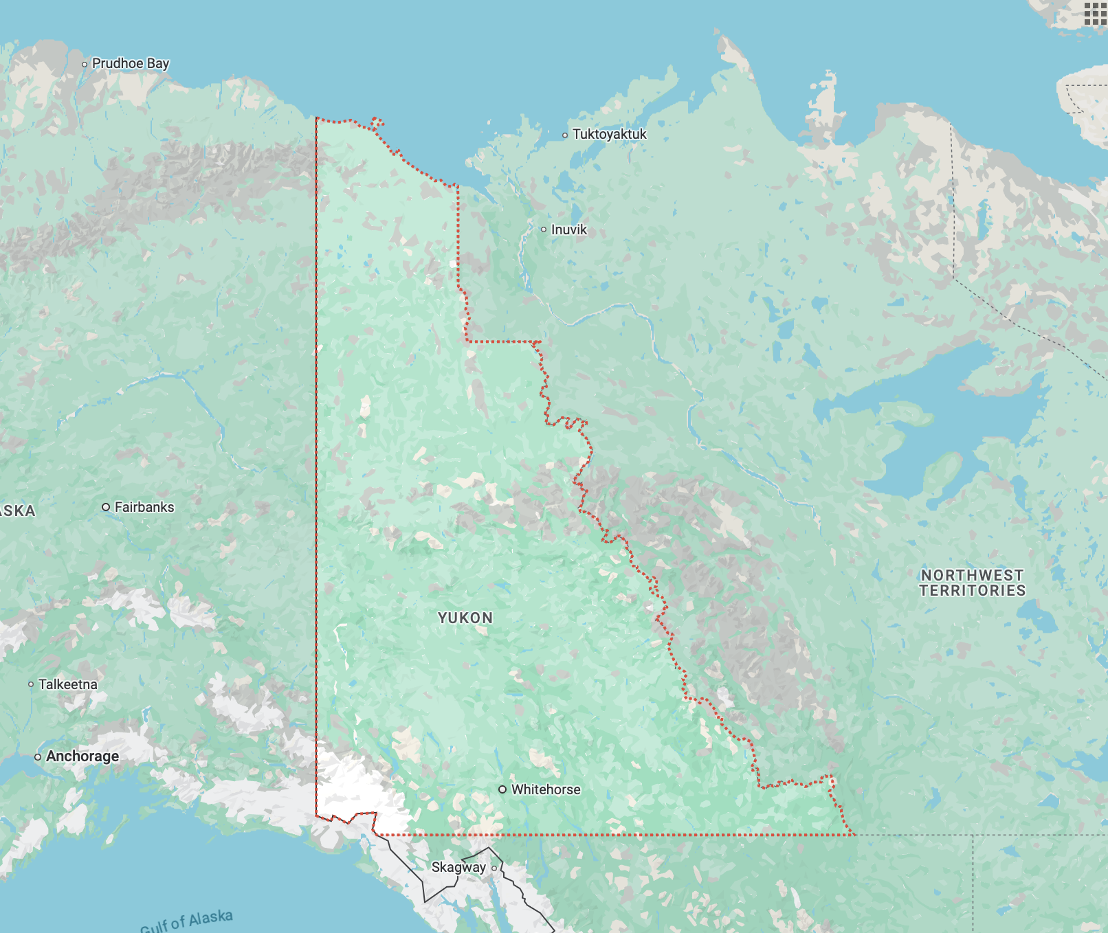A map of Yukon, Canada, highlighting its expansive wilderness and remote geography. The map shows surrounding locations such as the Northwest Territories to the east and Alaska to the west, with key towns like Whitehorse and Inuvik noted within the territory.
