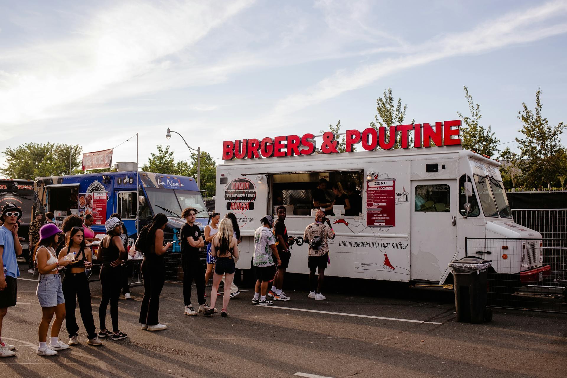 People lining up to order poutine at a food truck.