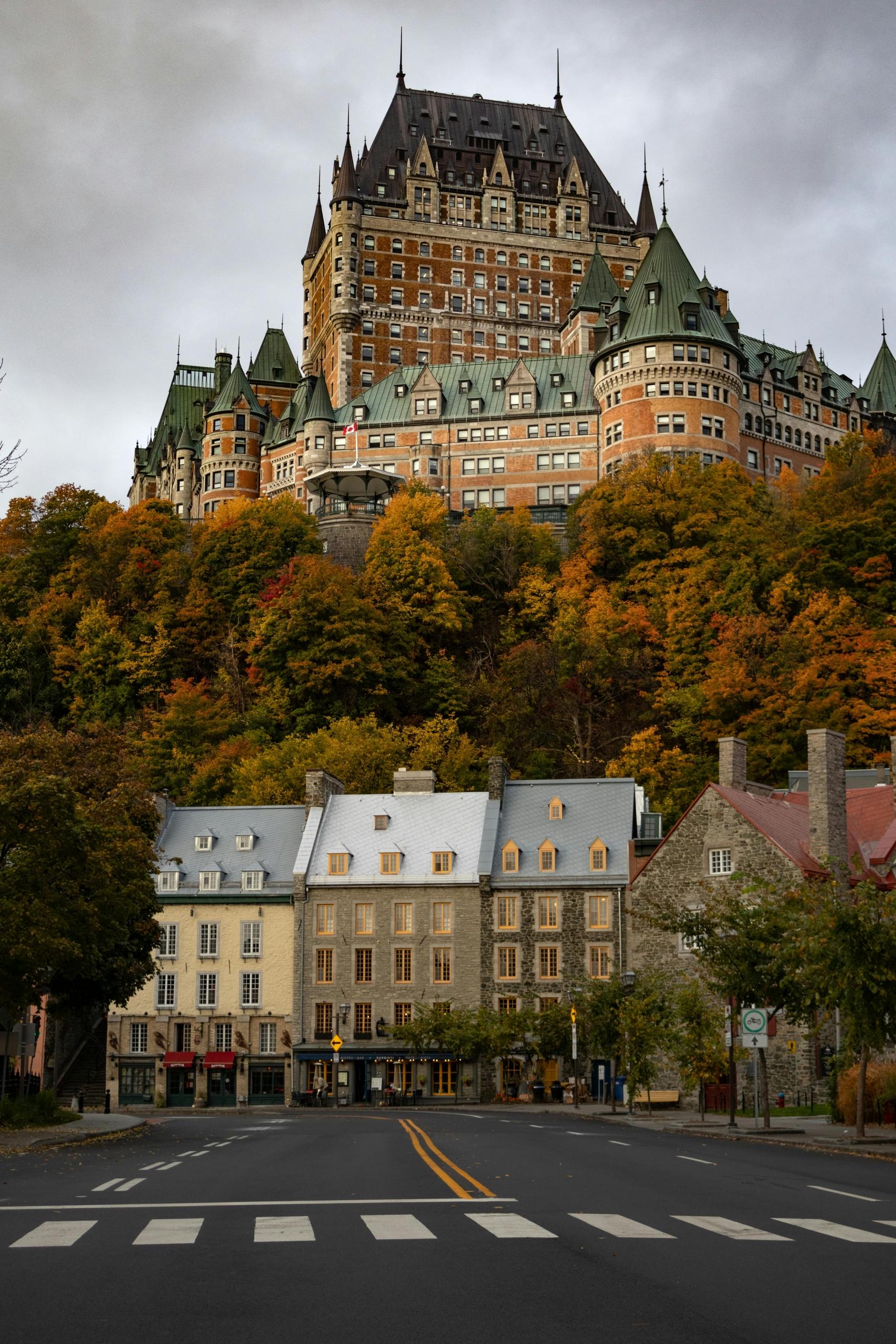 a view of Quebec City. The Fairmont Hotel Chateau Frontenac looms in the hill behind row houses.